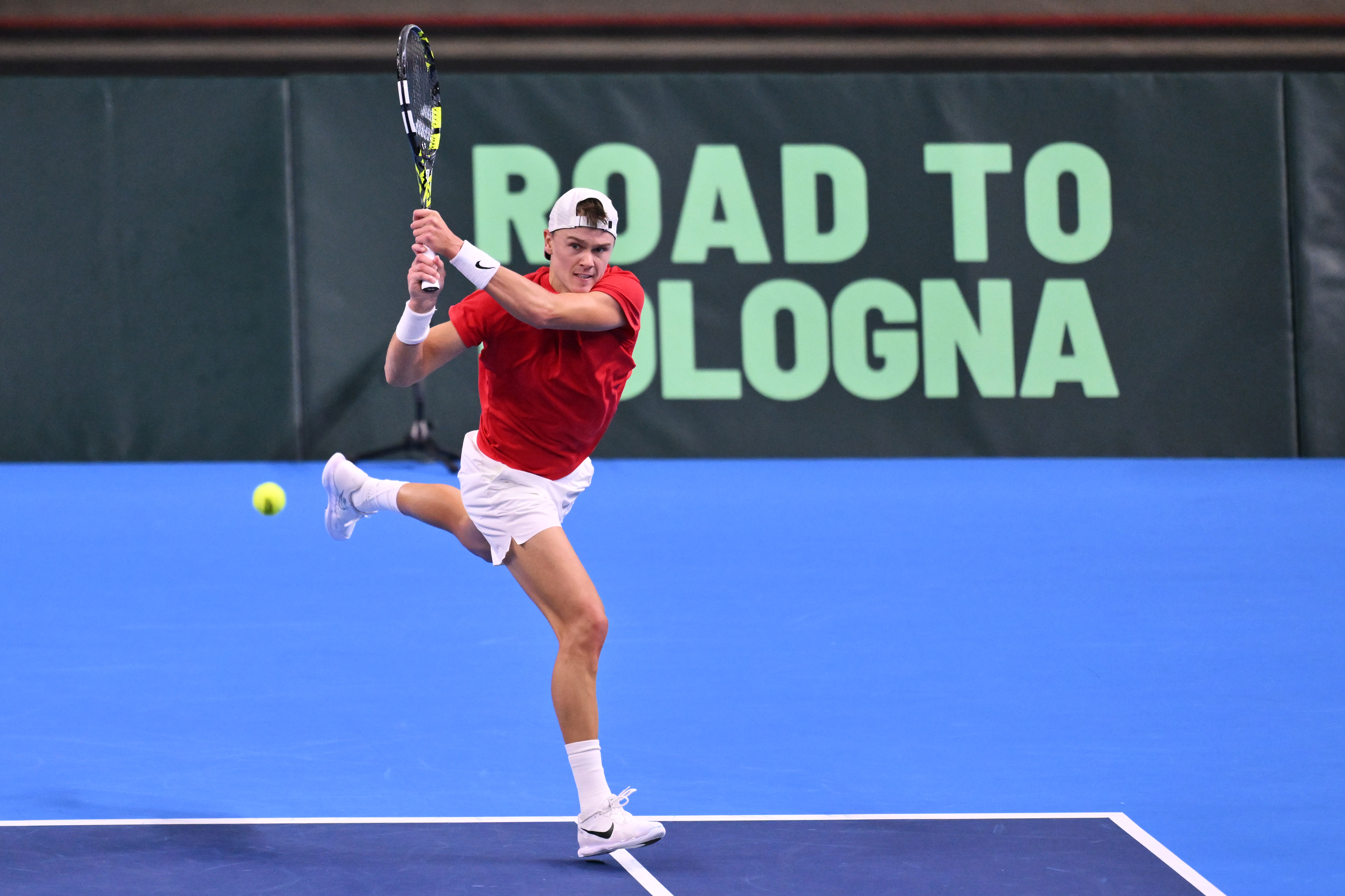 Holger Rune of Denmark hits a backhand