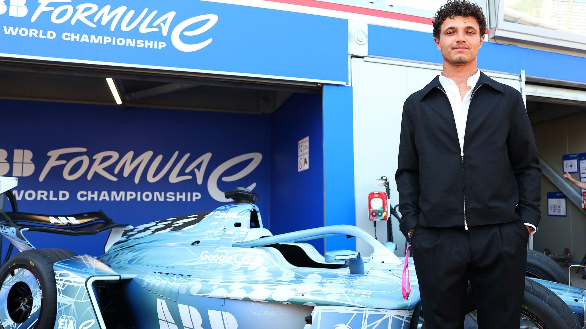 Lando Norris inspects the Formula E GEN4 car in Monaco