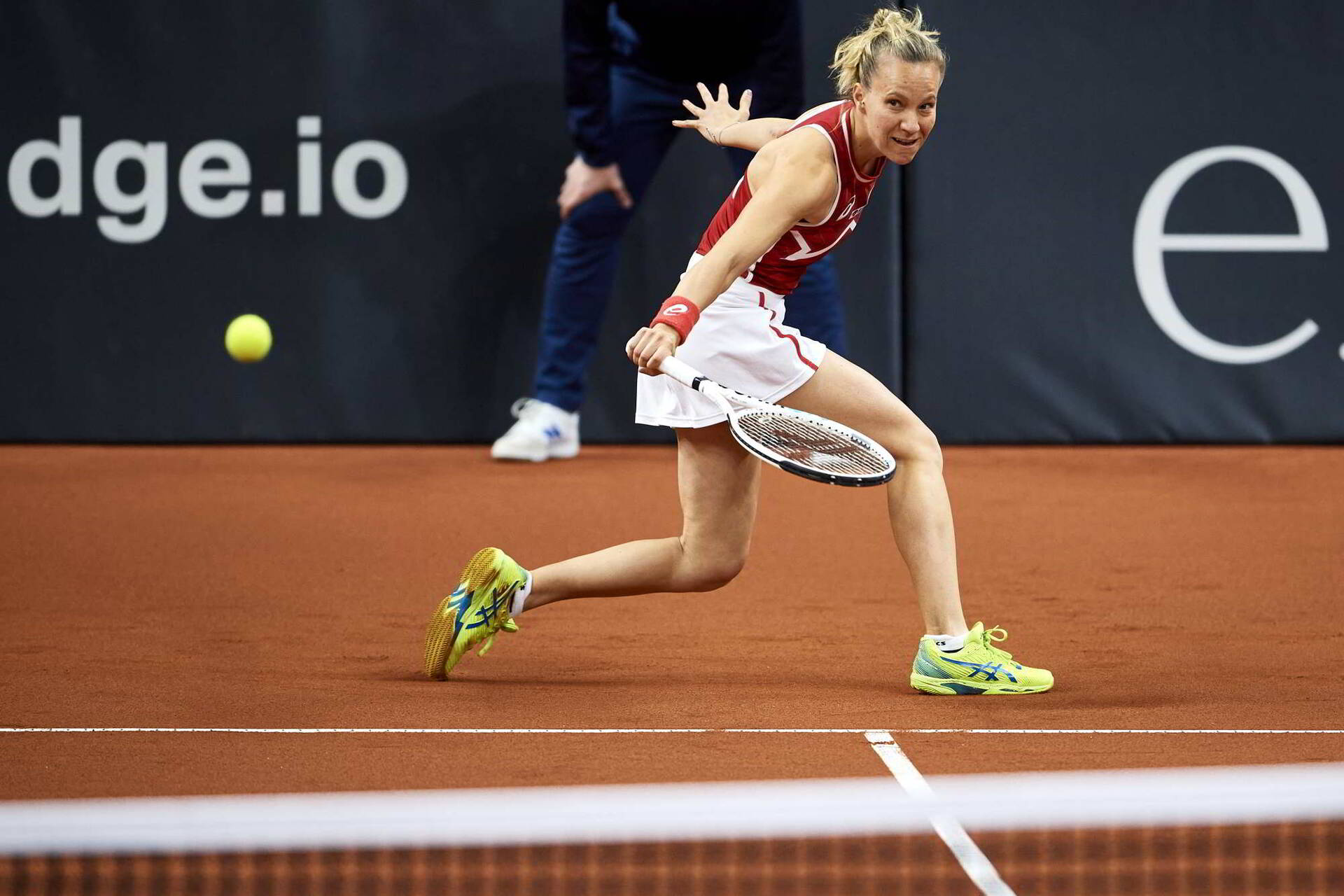 Viktorija Golubic slides into a backhand