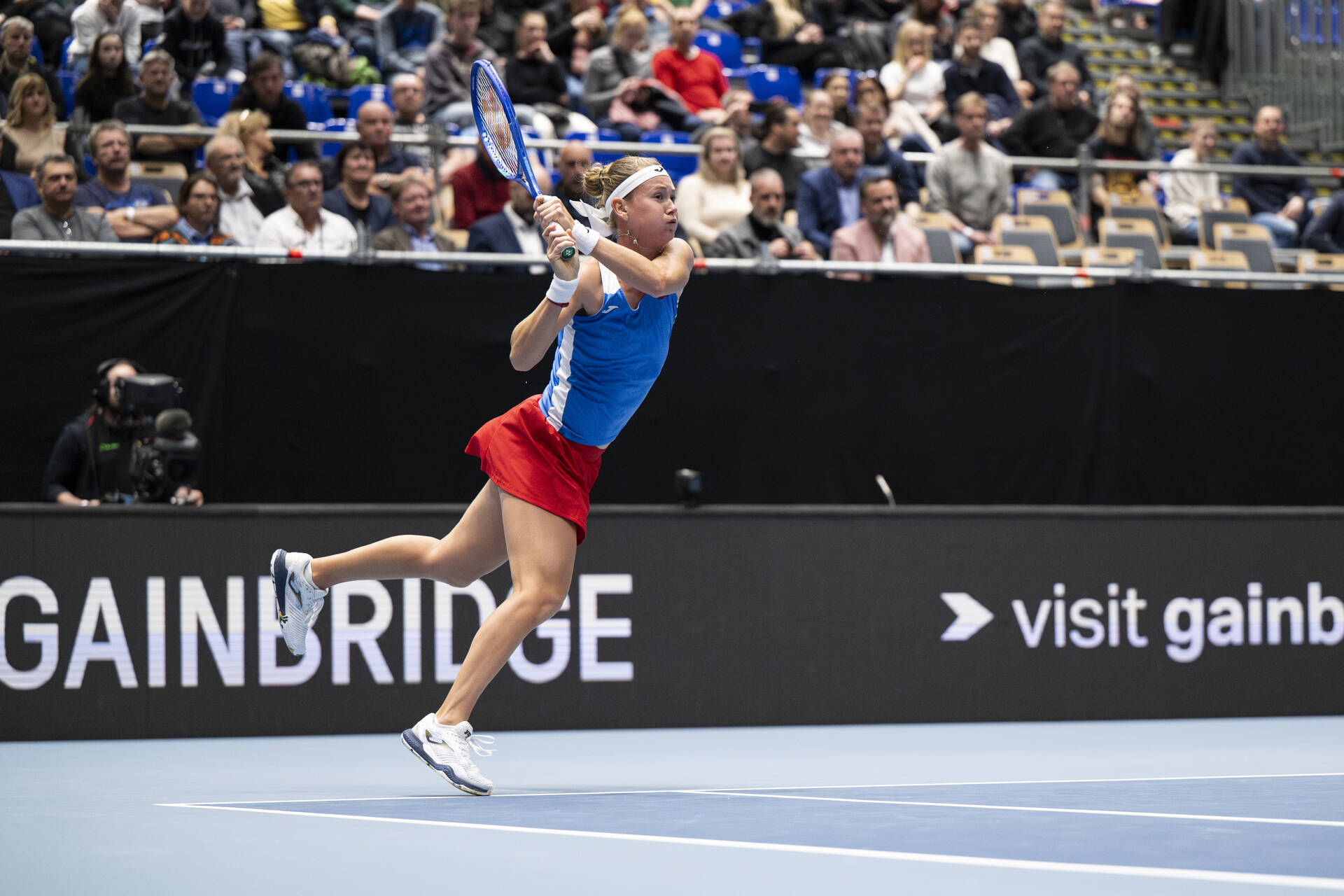 Marie Bouzkova hits a backhand during her win over Laura Pigossi