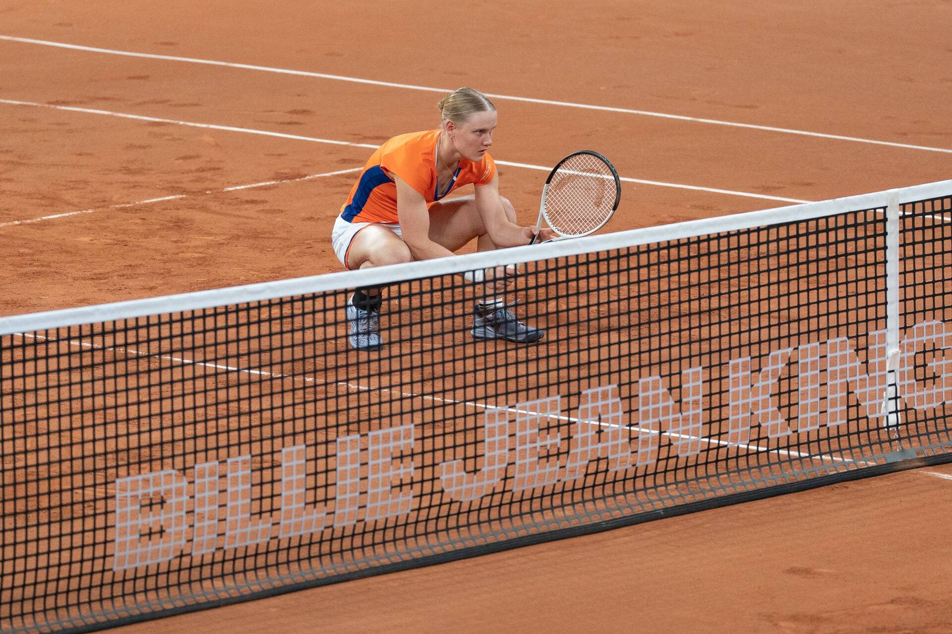 Suzan Lamens crouches at the net