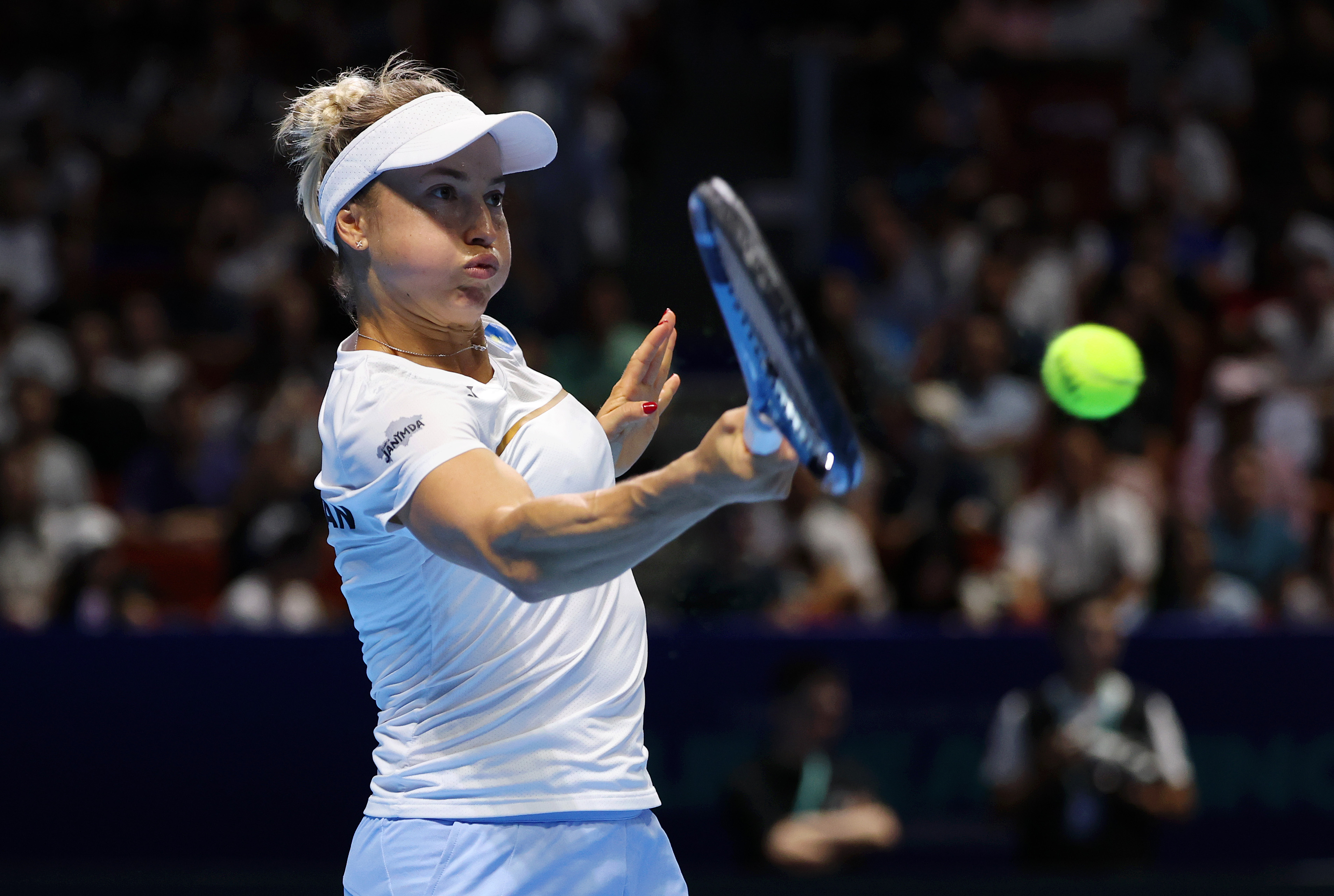 Yulia Putintseva plays a forehand shot