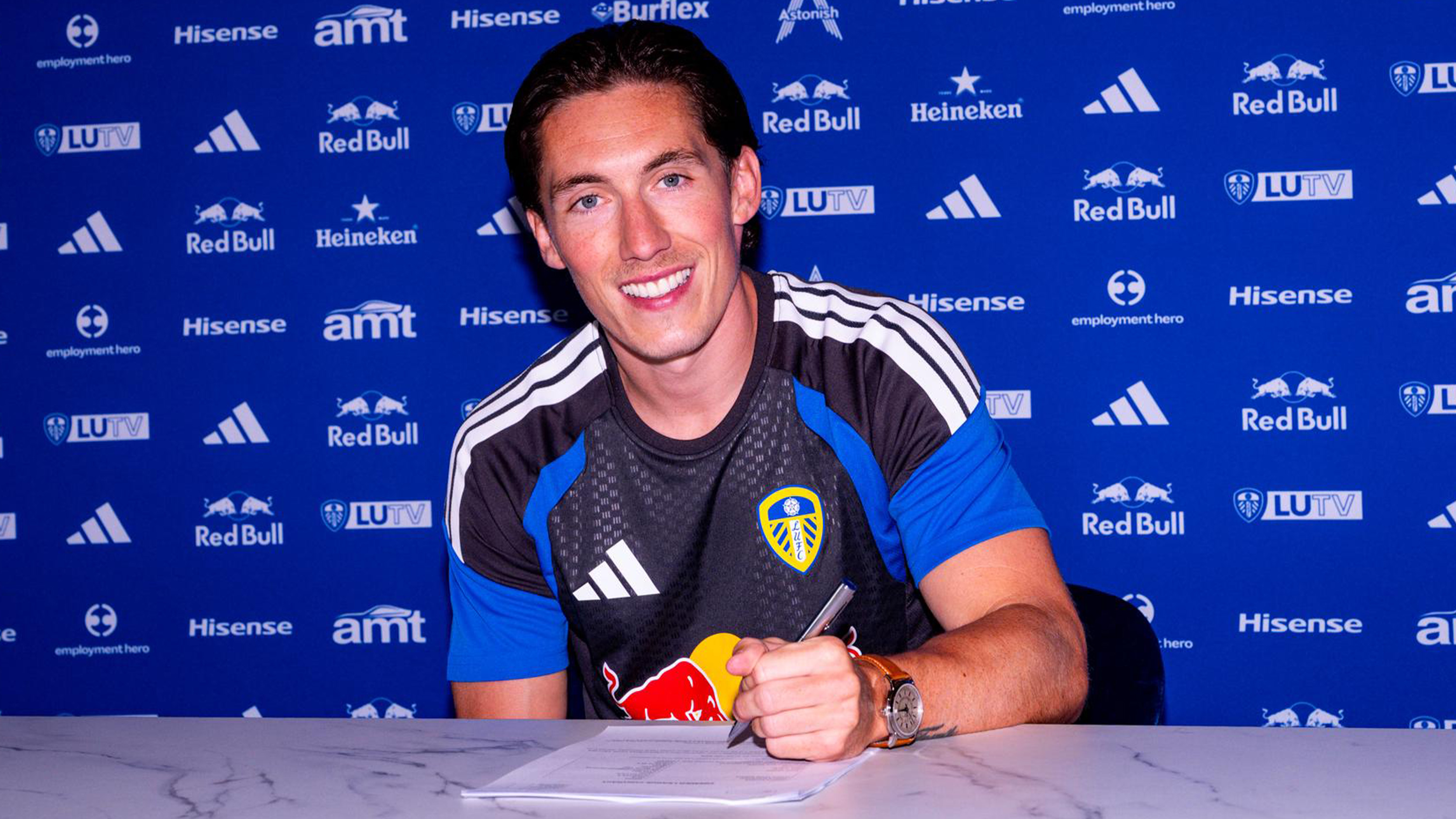 Harry Wilson Signing Jul 26 Smiling with Contract