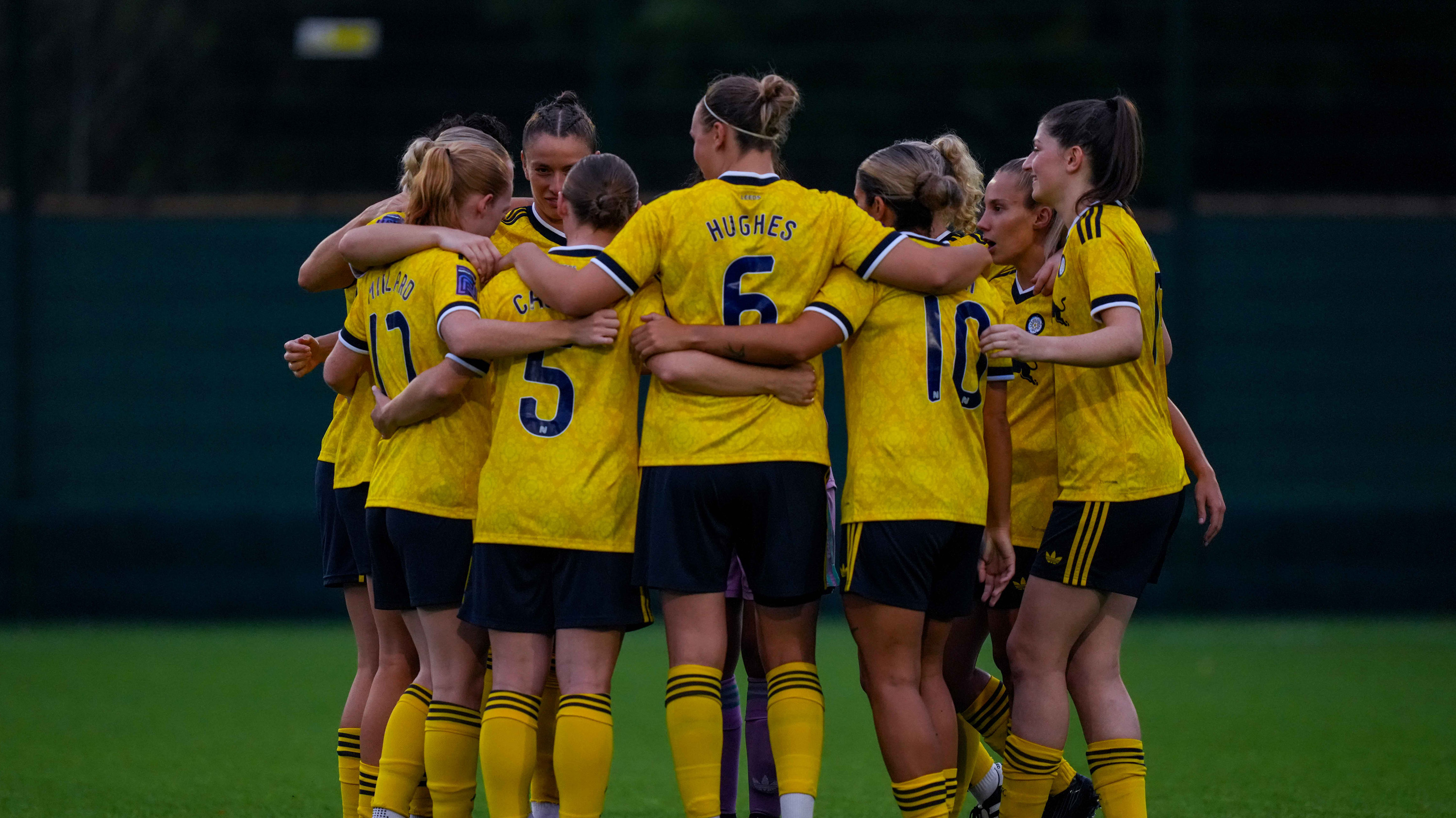 Women's team huddle Sep 26 yellow kit