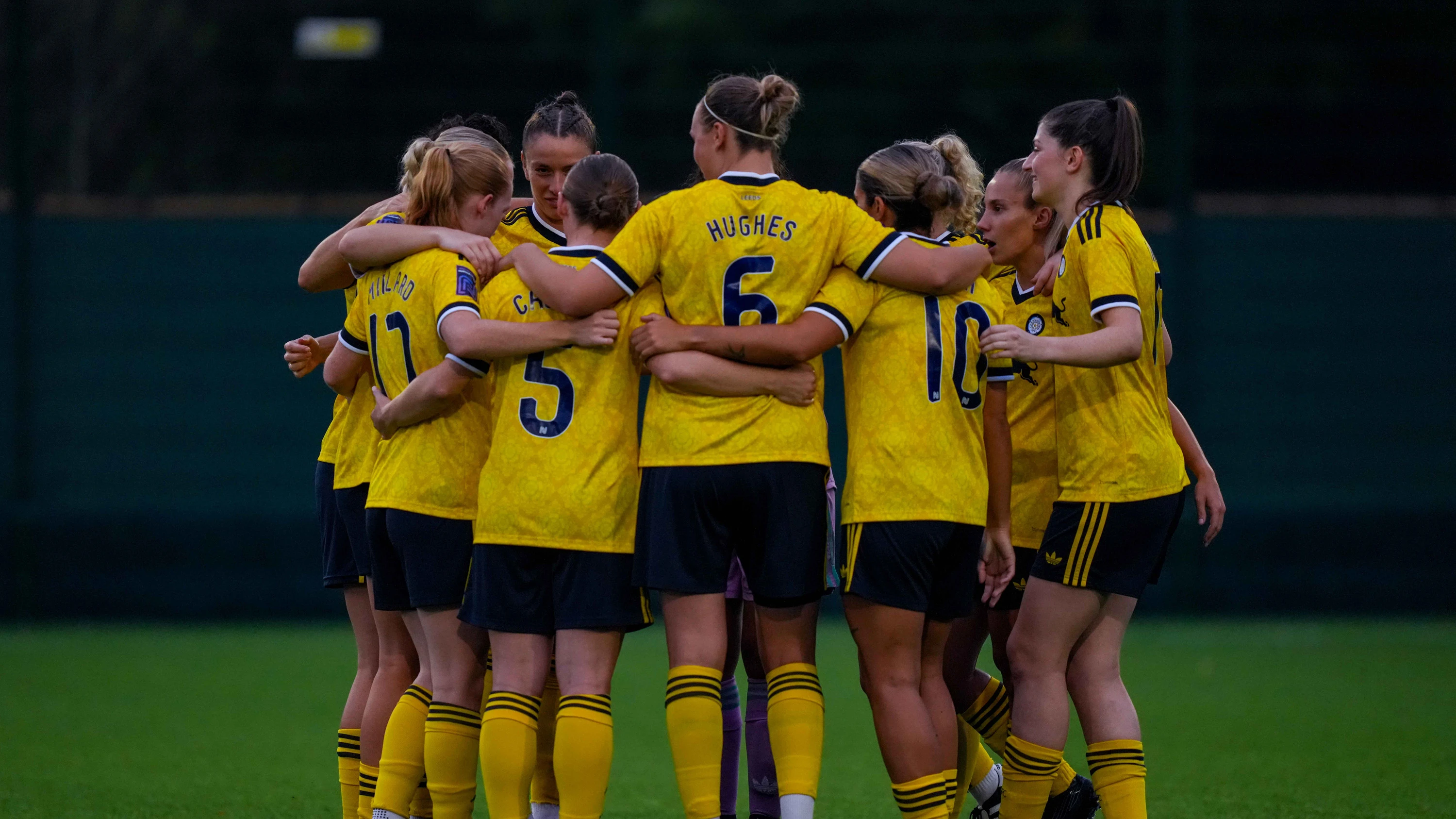 Women's team huddle Sep 26 yellow kit