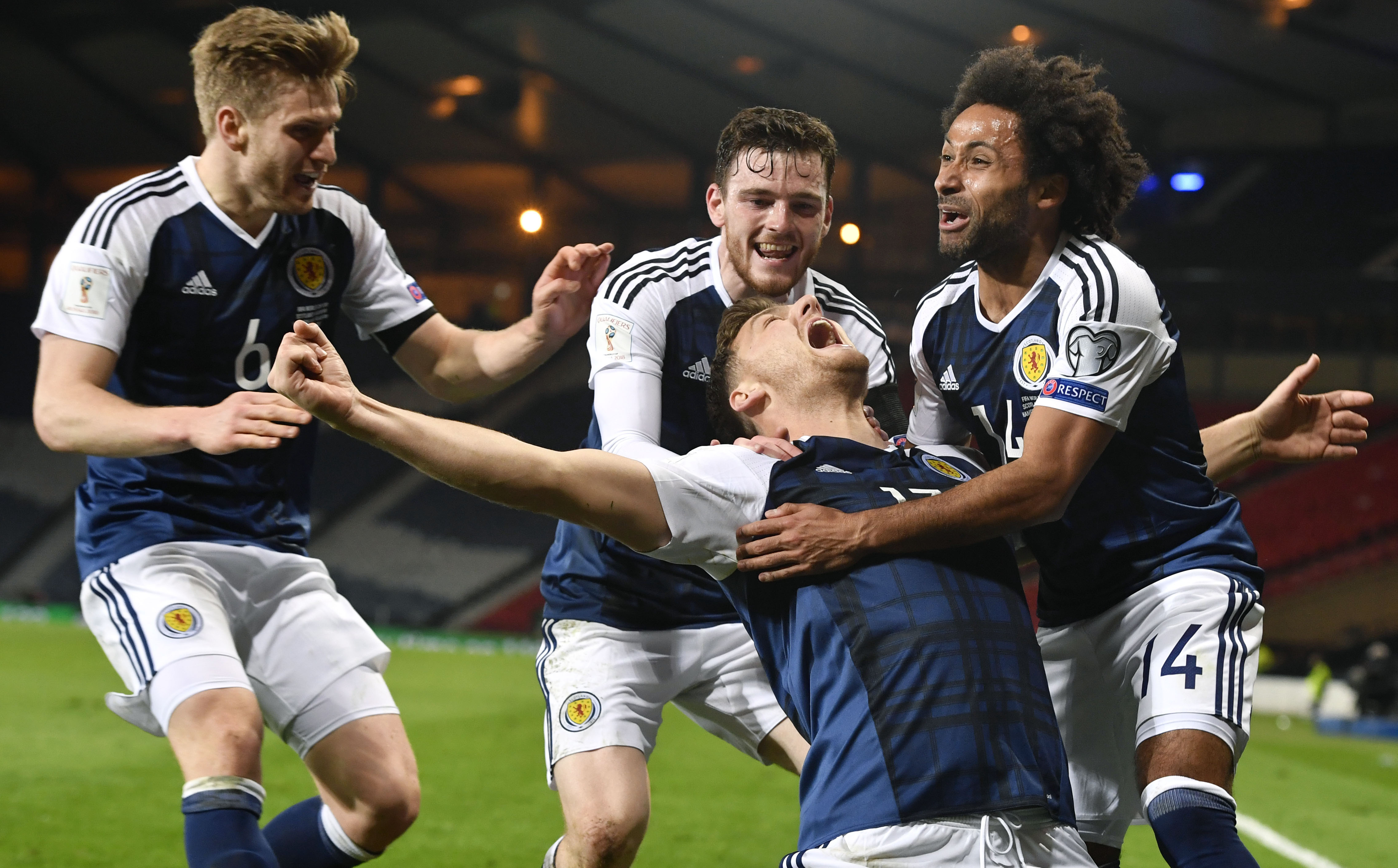 Chris Martin celebrates his winner with Stuart Armstrong, Ikechi Anya and Andy Robertson