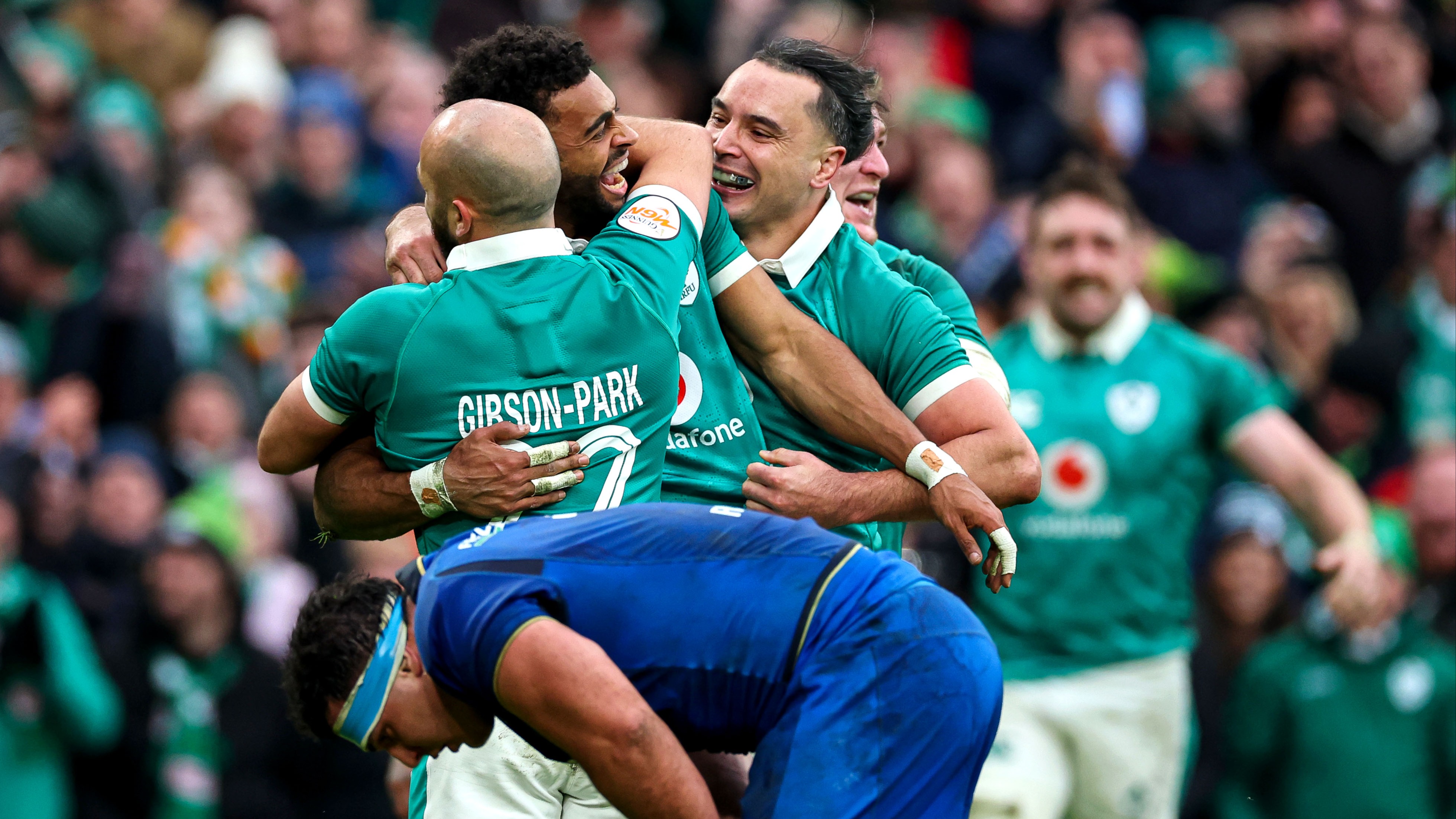 Ireland's Robert Baloucoune celebrates his try with Jamison Gibson-Park and James Lowe during the 2026 Guinness Six Nations Championship game against Italy in the Aviva Stadium, Dublin.