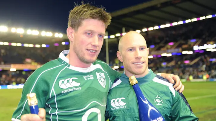 Ronan O'Gara and Peter Stringer hold bottles of champagne after winning the 2009 Grand Slam.