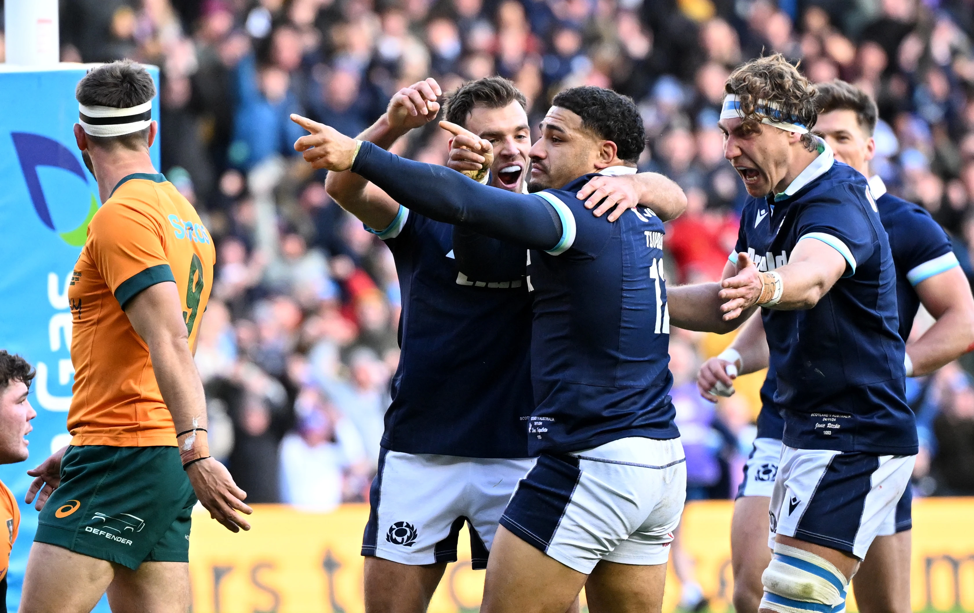 Scotland's Sione Tuipulotu celebrates scoring a try against Australia in 2024 with teammates