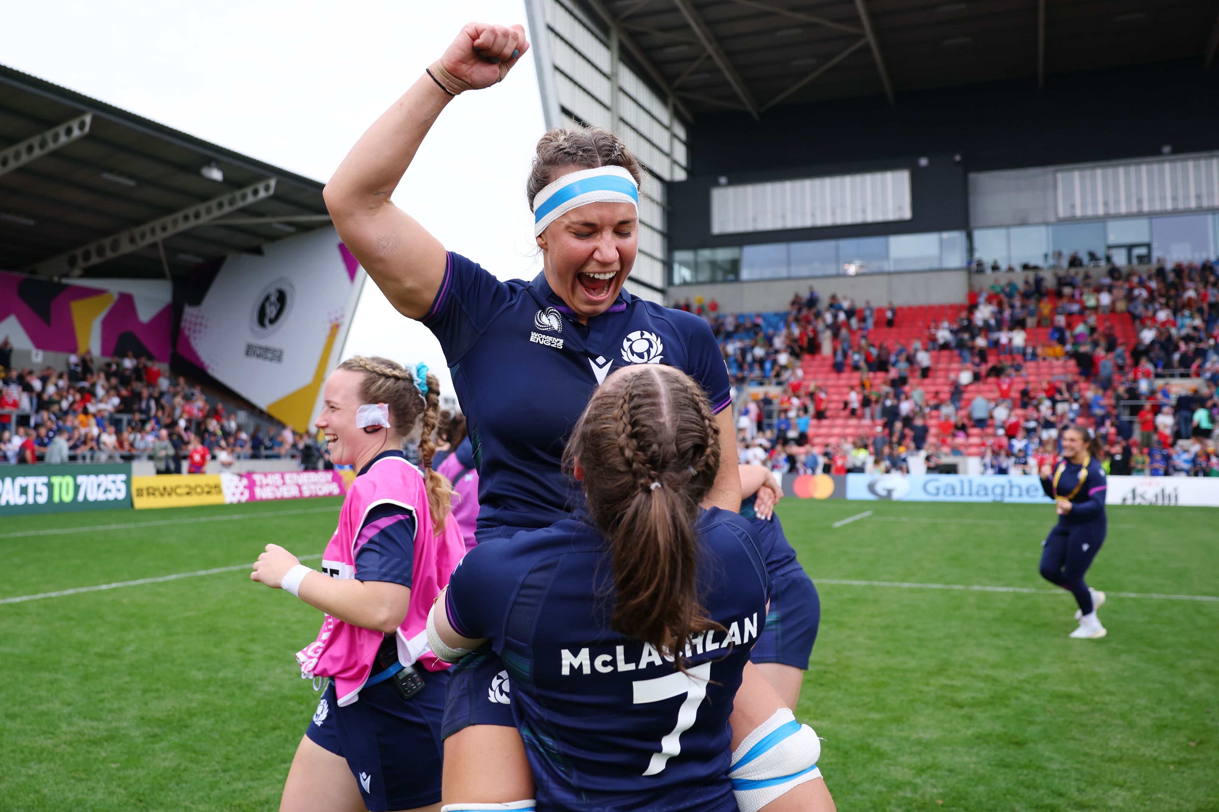 Rachel Malcolm is hoisted in the air by Rachel Maclachlan after Scotland's victory over Wales at the 2025 Rugby World Cup.