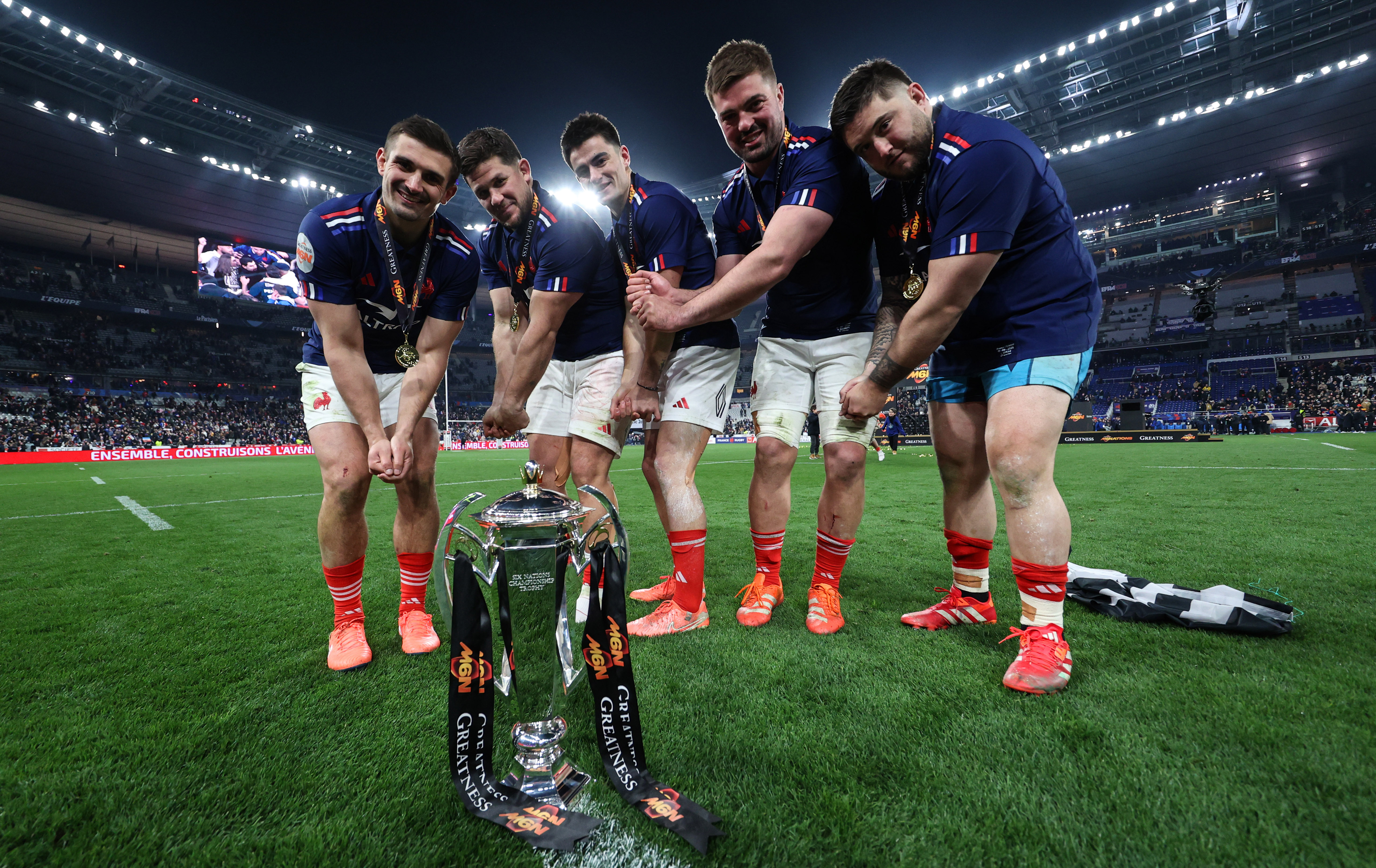France’s Thomas Ramos, Julien Marchand, Nolann Le Garrec, Gregory Alldritt and Cyril Baille pretend to swing a golf club in front of the trophy in 2025.