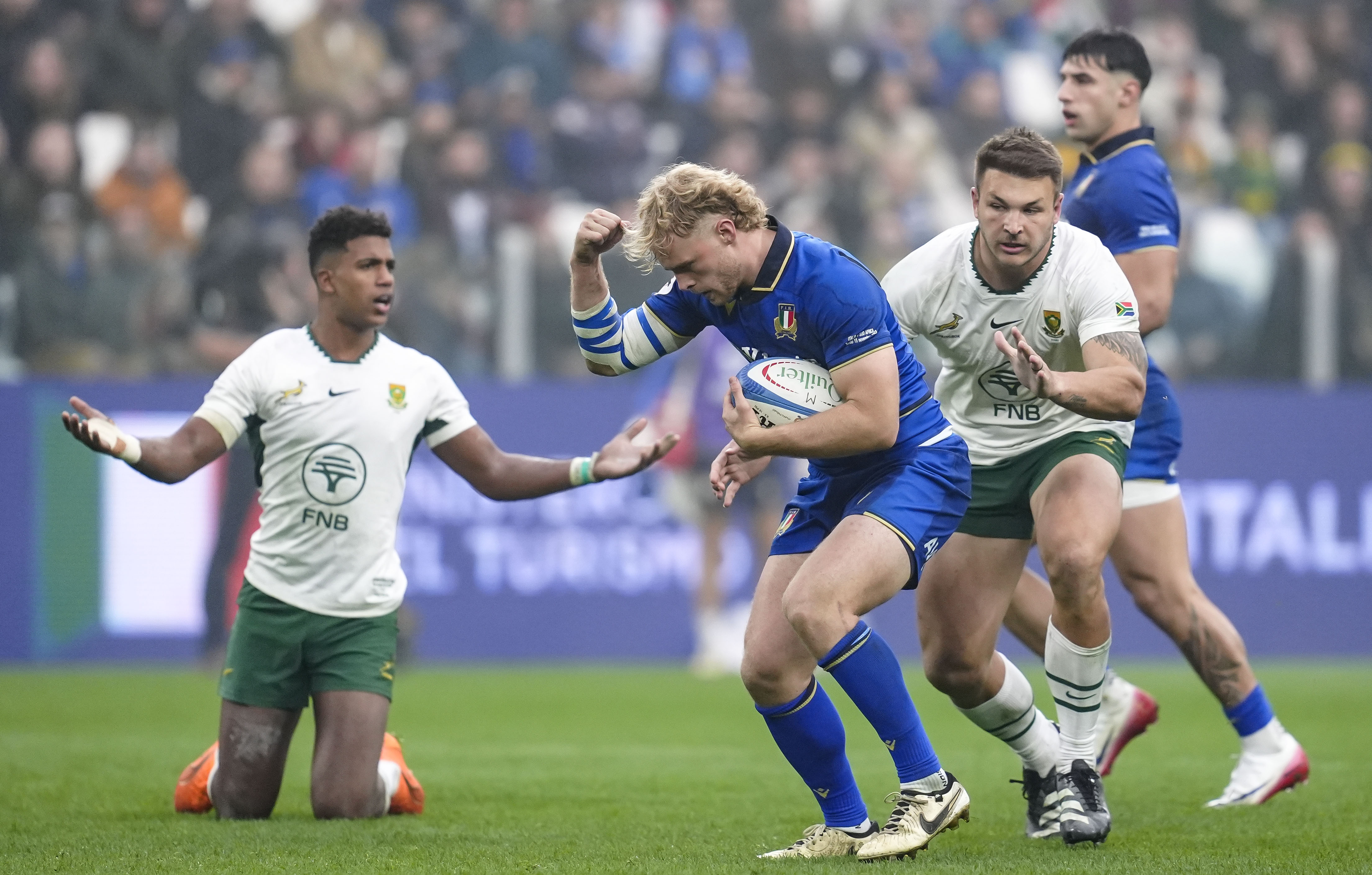 Italy's Louis Lynagh is closed down by South Africa's Andre Esterhuizen during the 2025 Quilter Nations Series game between Italy and South Africa in Allianz Stadium, Turin