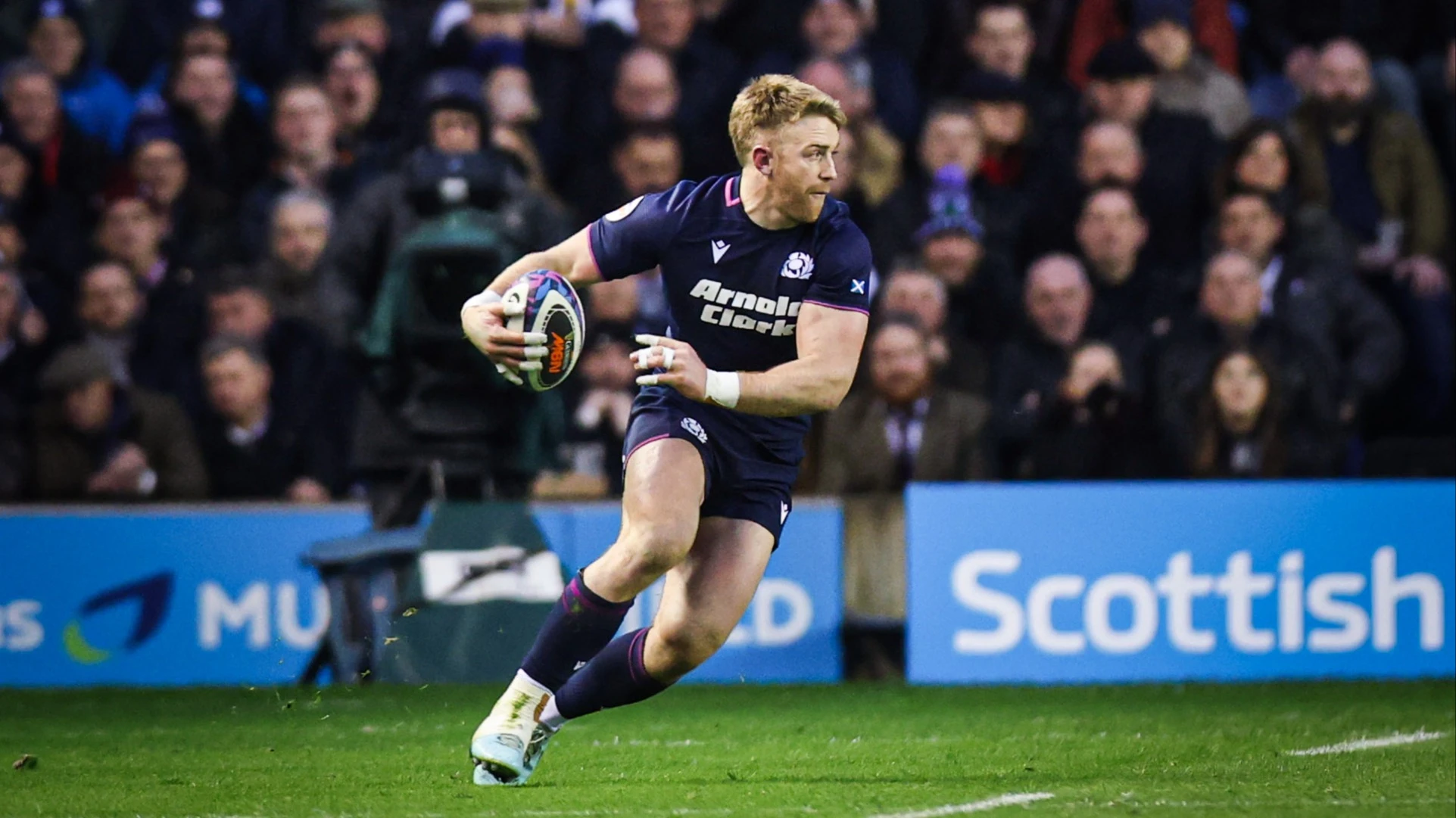 Scotland's Kyle Steyn on the attack against a backdrop of fans during the 2026 Calcutta Cup match in Edinburgh.