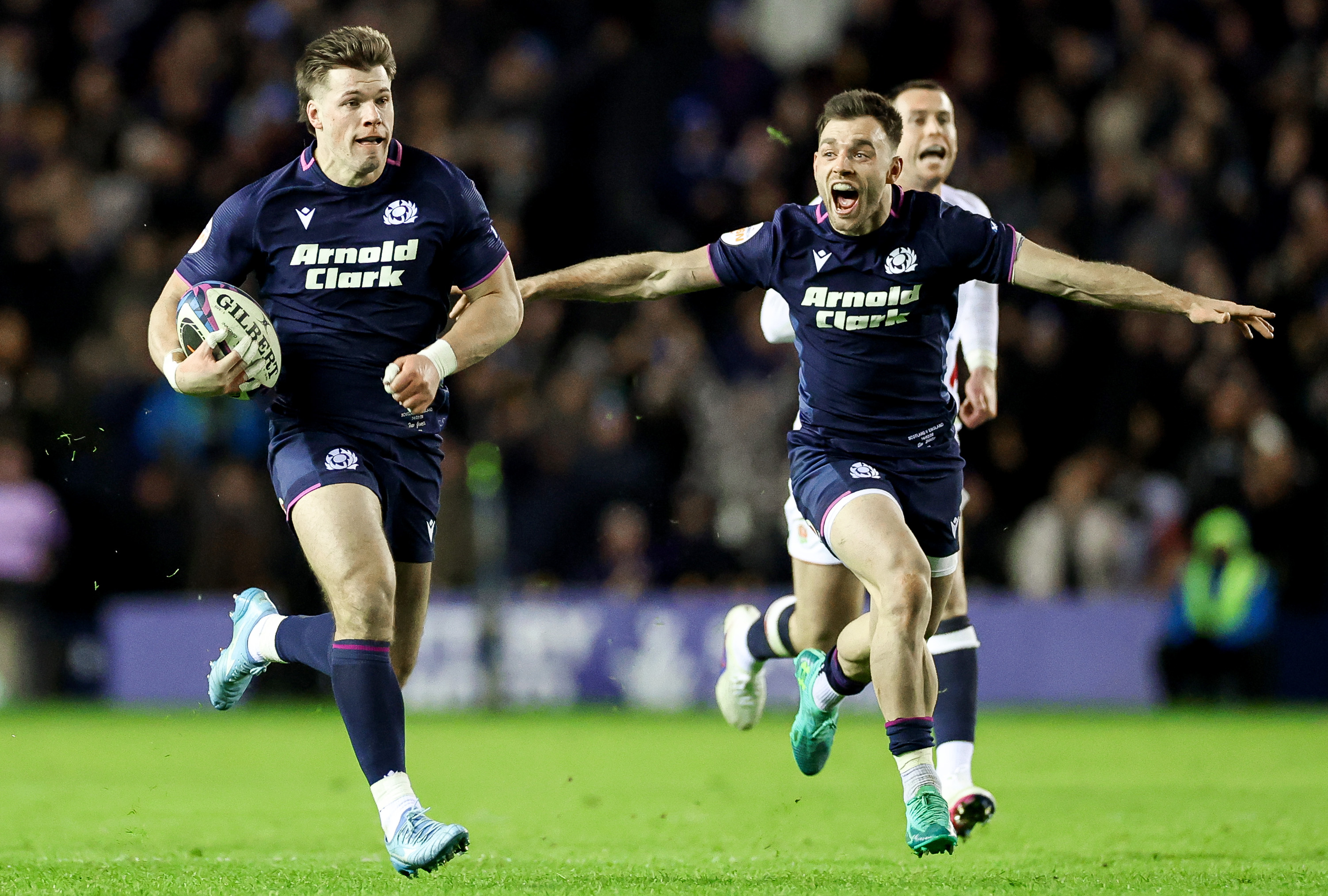 Huw Jones runs in for a try against England in the 2026 Championship as Ben White cheers him on.