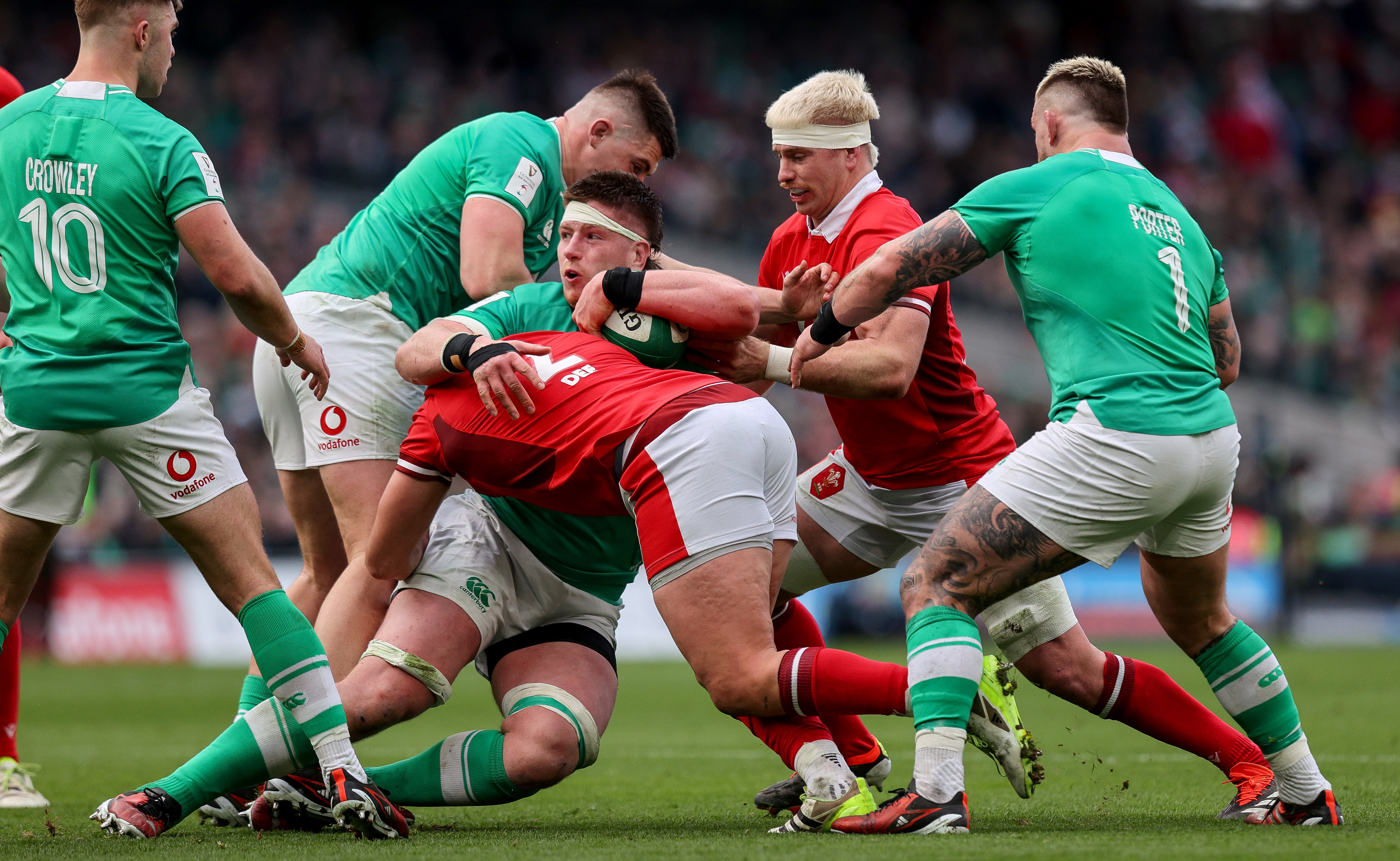 Ireland's Joe McCarthy is tackled by Wales' Elliot Dee and Aaron Wainwright during the 2024 Guinness Six Nations Championship Round 3 between Ireland and Wales in the Aviva Stadium, 