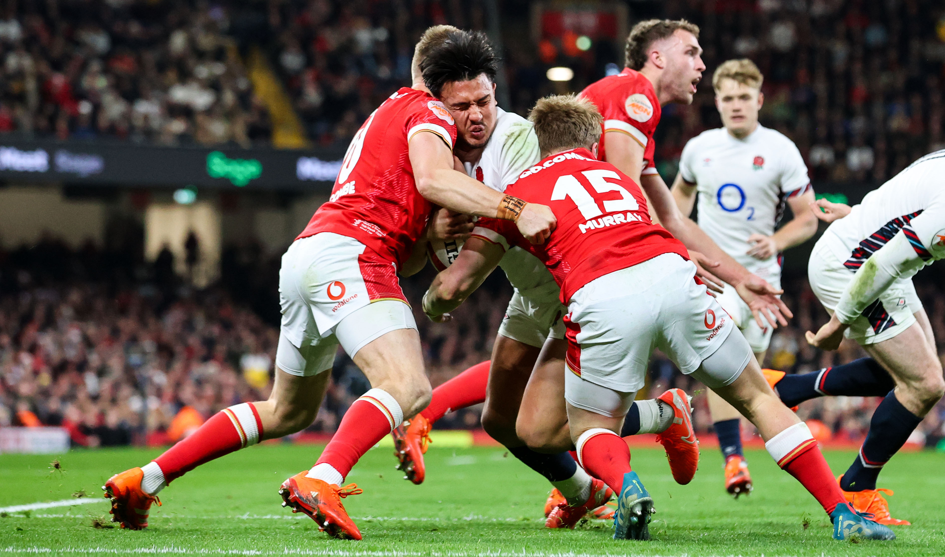 England's Marcus Smith is tackled heavily by the Welsh defence during the 2025 Guinness Men's Six Nations Championship