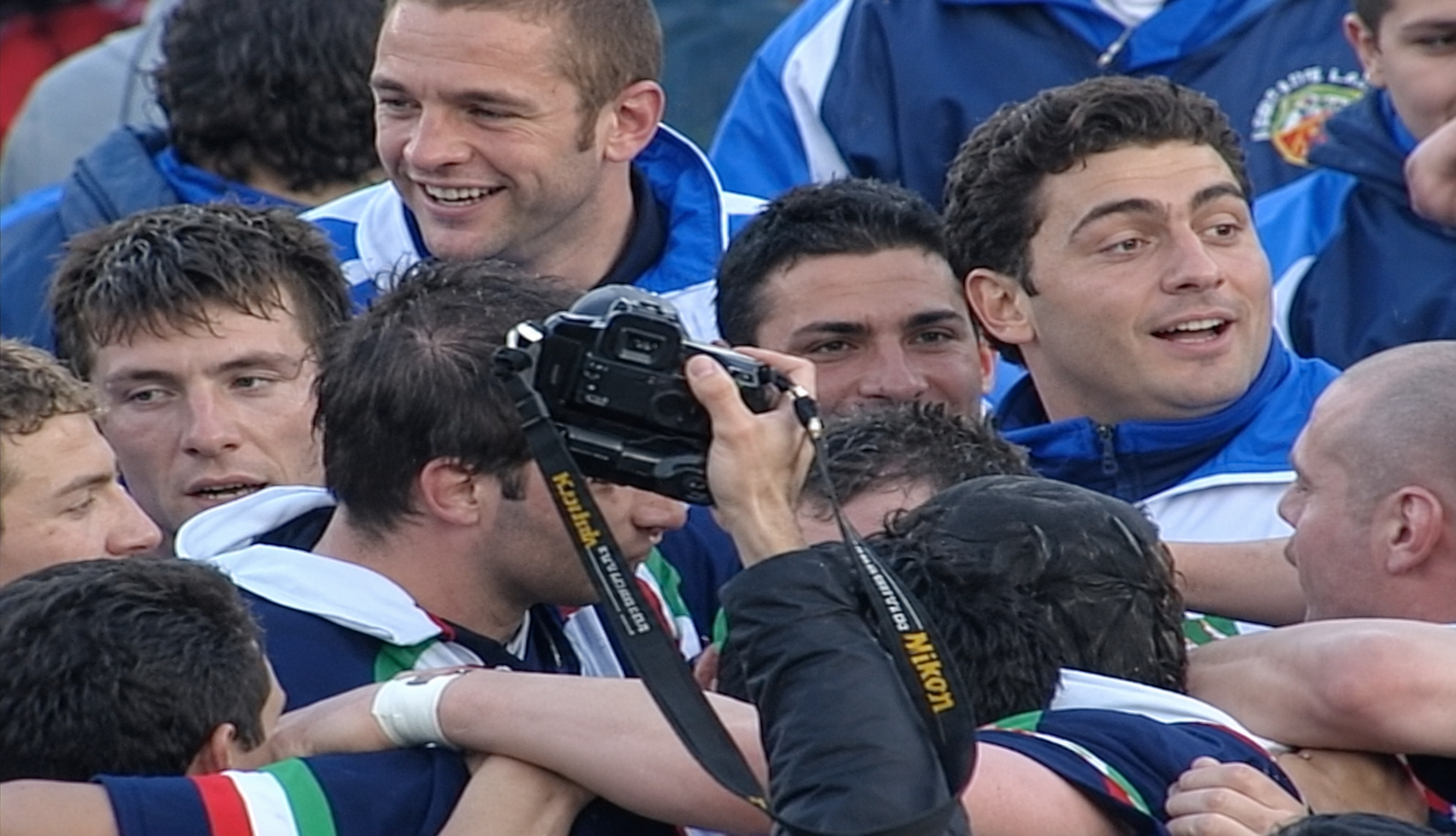 Italy's players swarm each other in celebration after beating Scotland in the opening round of the first-ever Six Nations in 2000.