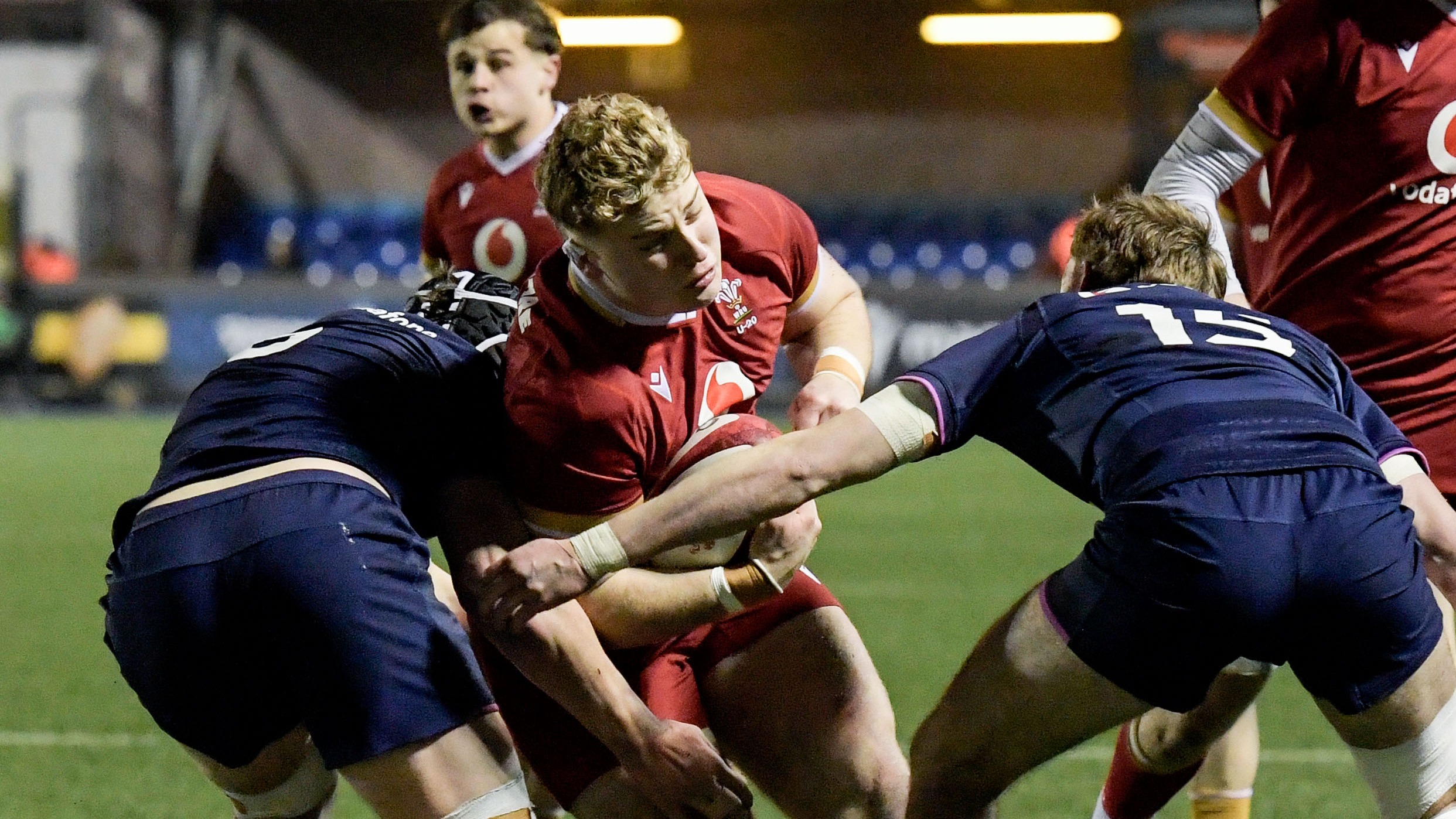 Wales' George Tuckley tackled by Scotland’s Sam Byrd and Henry Widdowson during the 2026 Under 20 Six Nations Championship.