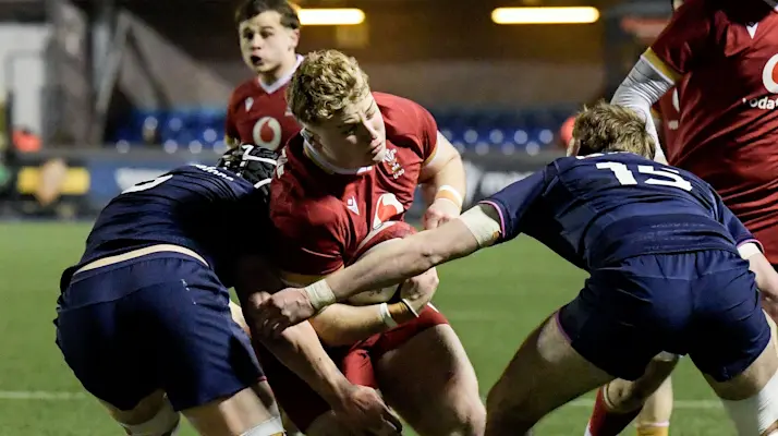 Wales' George Tuckley tackled by Scotland’s Sam Byrd and Henry Widdowson during the 2026 Under 20 Six Nations Championship.