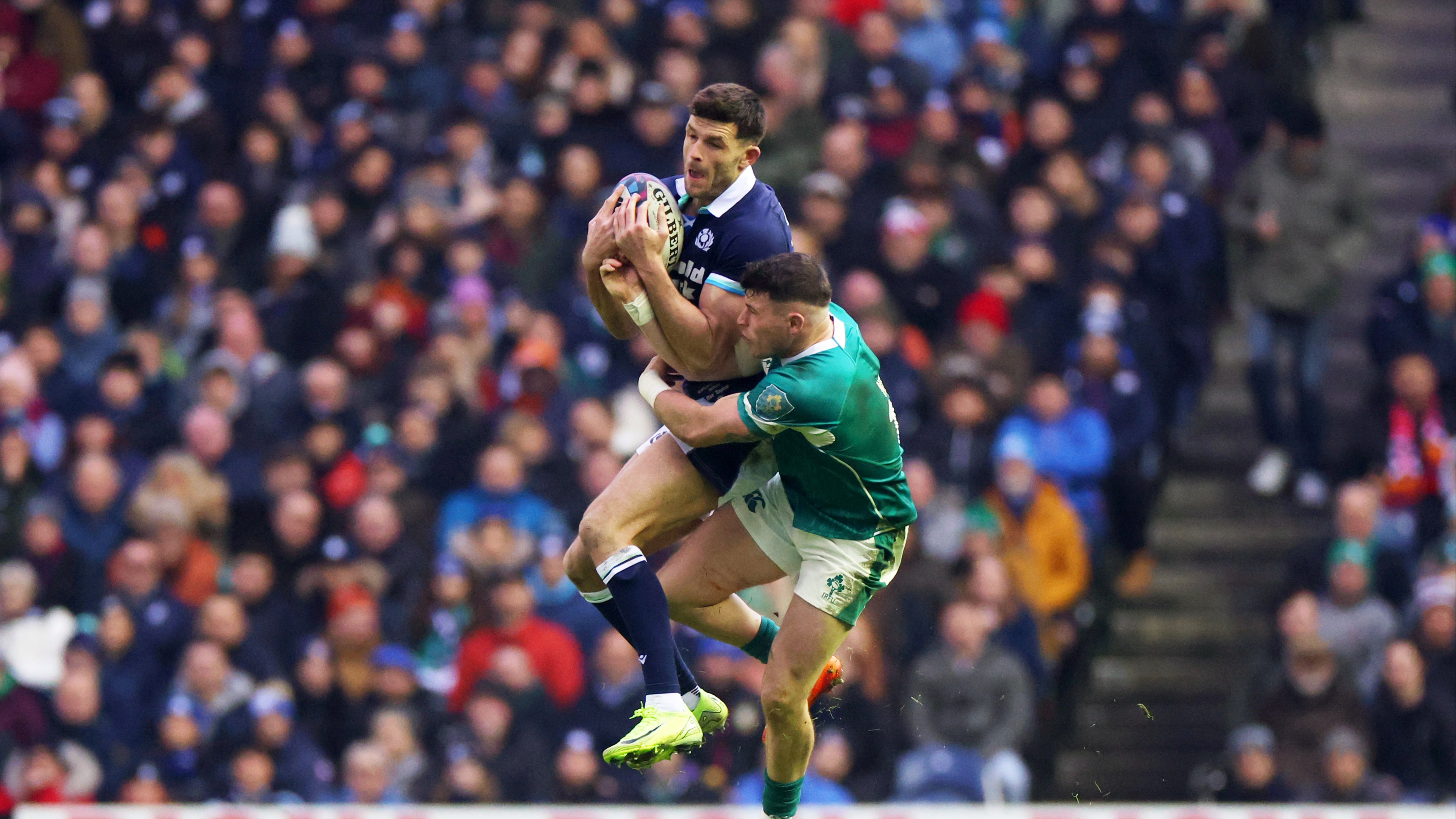 Scotland's Blair Kinghorn and Ireland's Hugo Keenan compete for the high ball during the teams' 2025 Championship match.