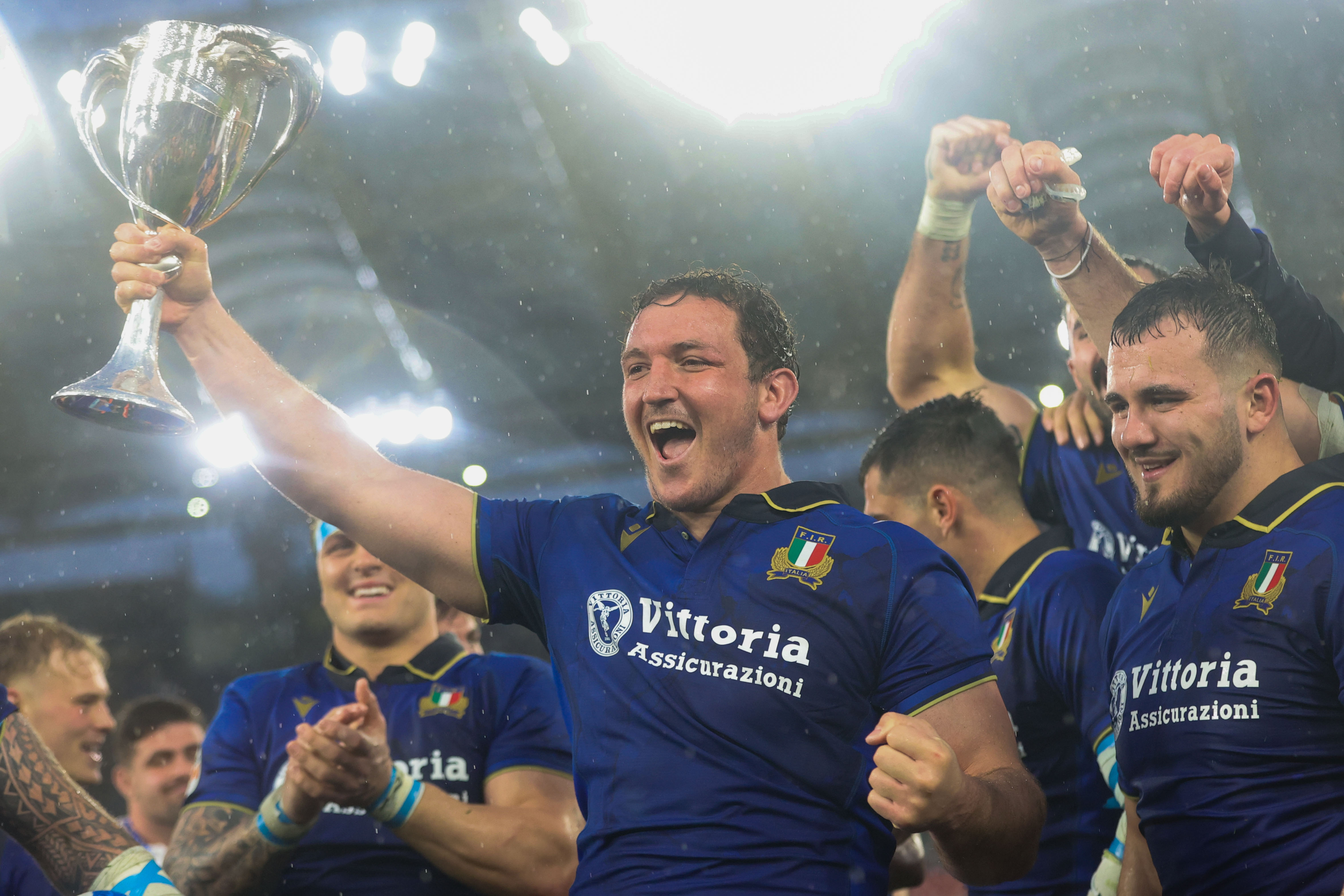 Michele Lamaro, flanked by his Italy teammates, raises the Cuttita Cup following the win over Scotland in the 2026 Championship.