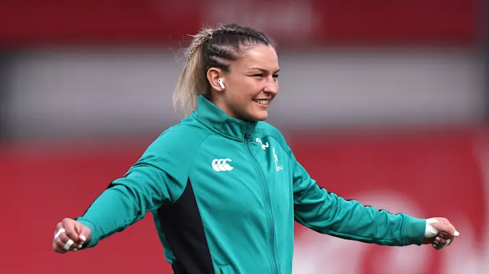 A smiling Erin King warms up for a 2025 Guinness Women's Six Nations match.