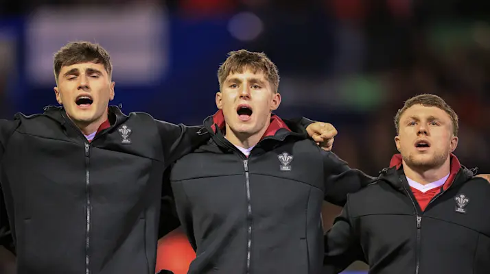 Wales' Osian Darwin-Lewis, Steffan Emanuel and Tom Bowen during the national anthem before the 2026 Under 20 Six Nations Championship match against France.