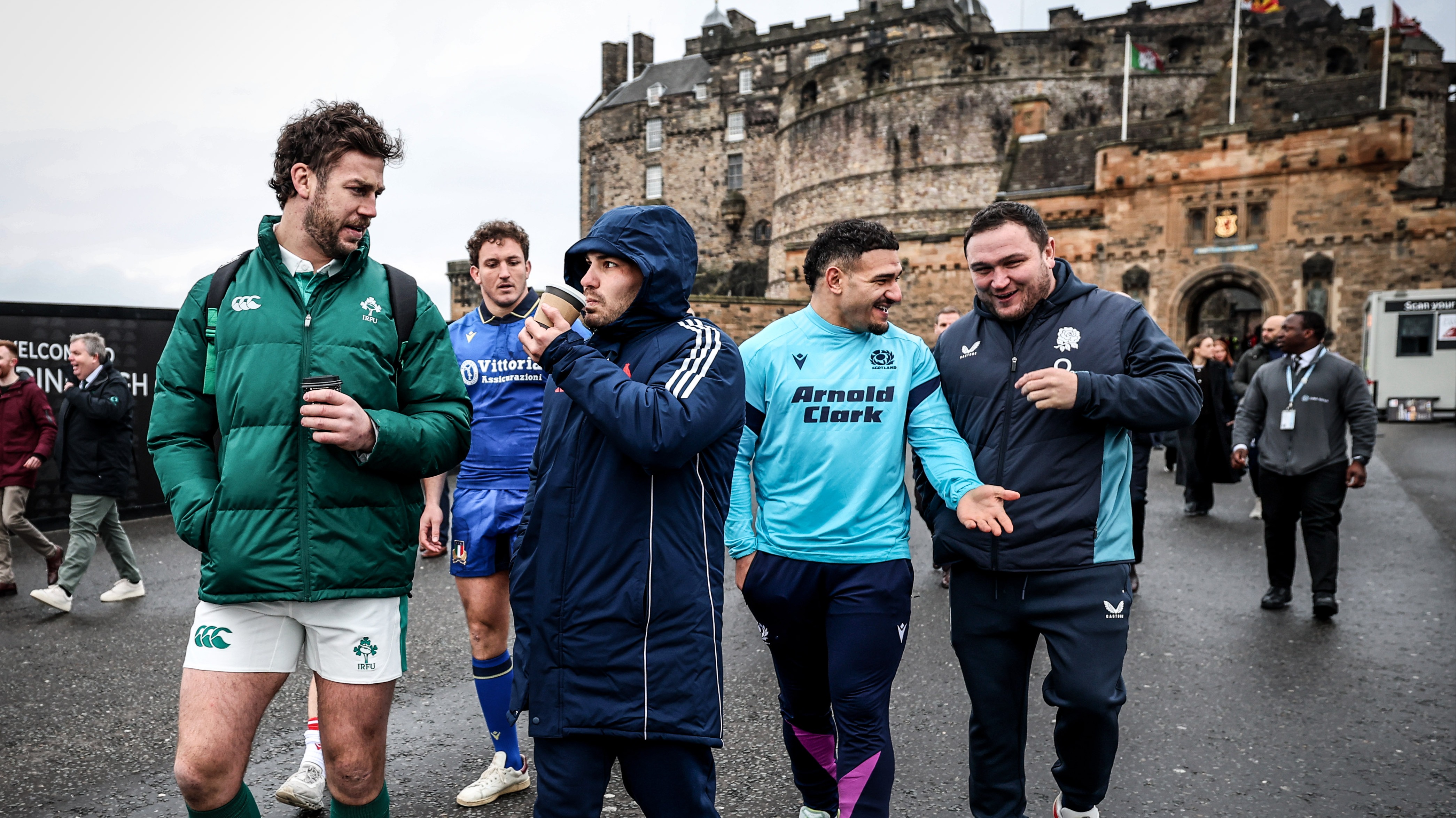 Caelan Doris, Antoine Dupont, Michele Lamaro, Jamie George and Sione Tuipulotu walking outside Edinburgh Castle.