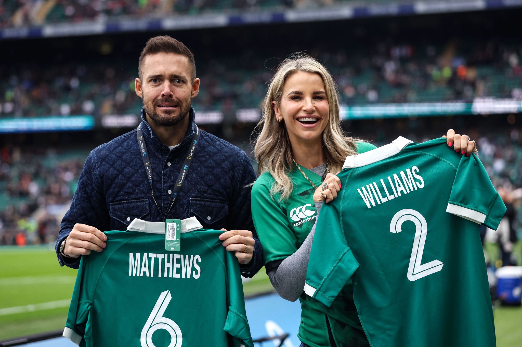 Spencer Matthews and Vogue Williams hold up their personalised Irish Rugby jerseys at Allianz Stadium ahead of the round three clash in 2026.