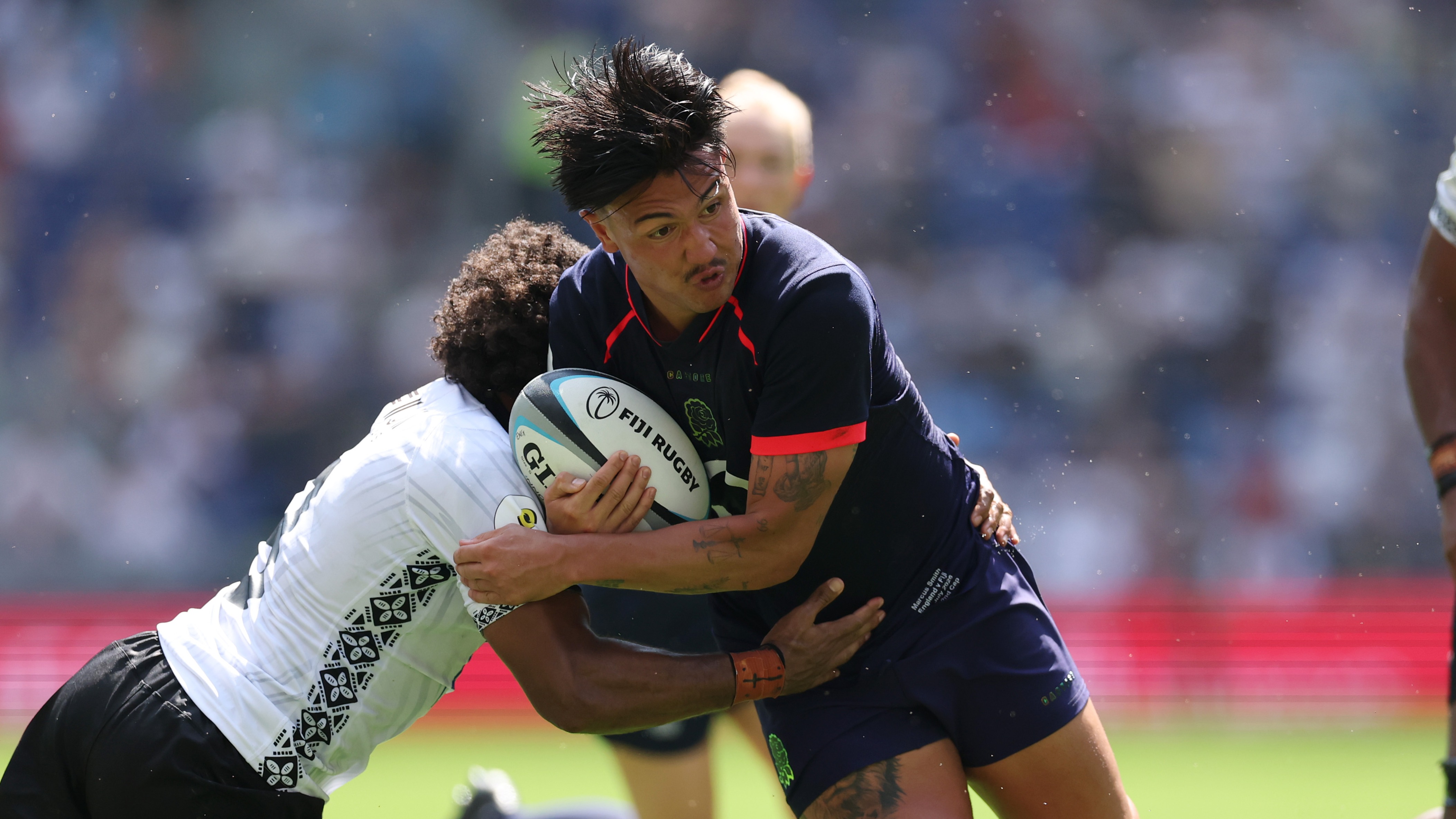 Marcus Smith of England is tackled by Simione Kuruvoli of Fiji during the 2026 Nations Championship match between Fiji and England at Hill Dickinson Stadium on July 11, 2026