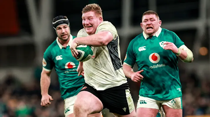 A smiling Rhys Carre is chased by Caelan Doris and Tadhg Furlong as he races away for a try in the 2026 Championship.