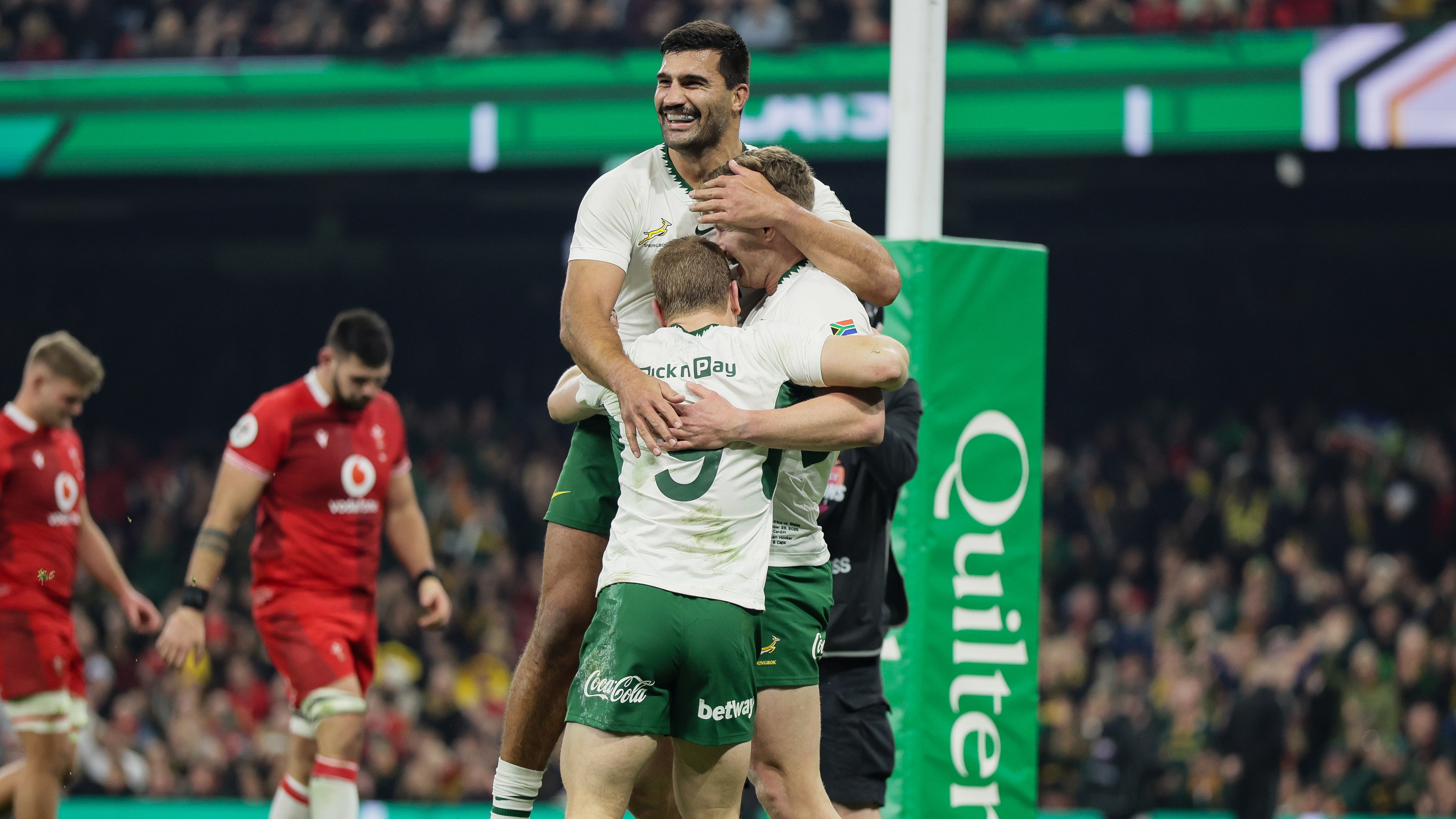 South Africa's Ethan Hooker celebrates with Morne van den Berg and Damian de Allende after scoring his side's second try of the match against Wales during the 2025 Quilter Nations Series.