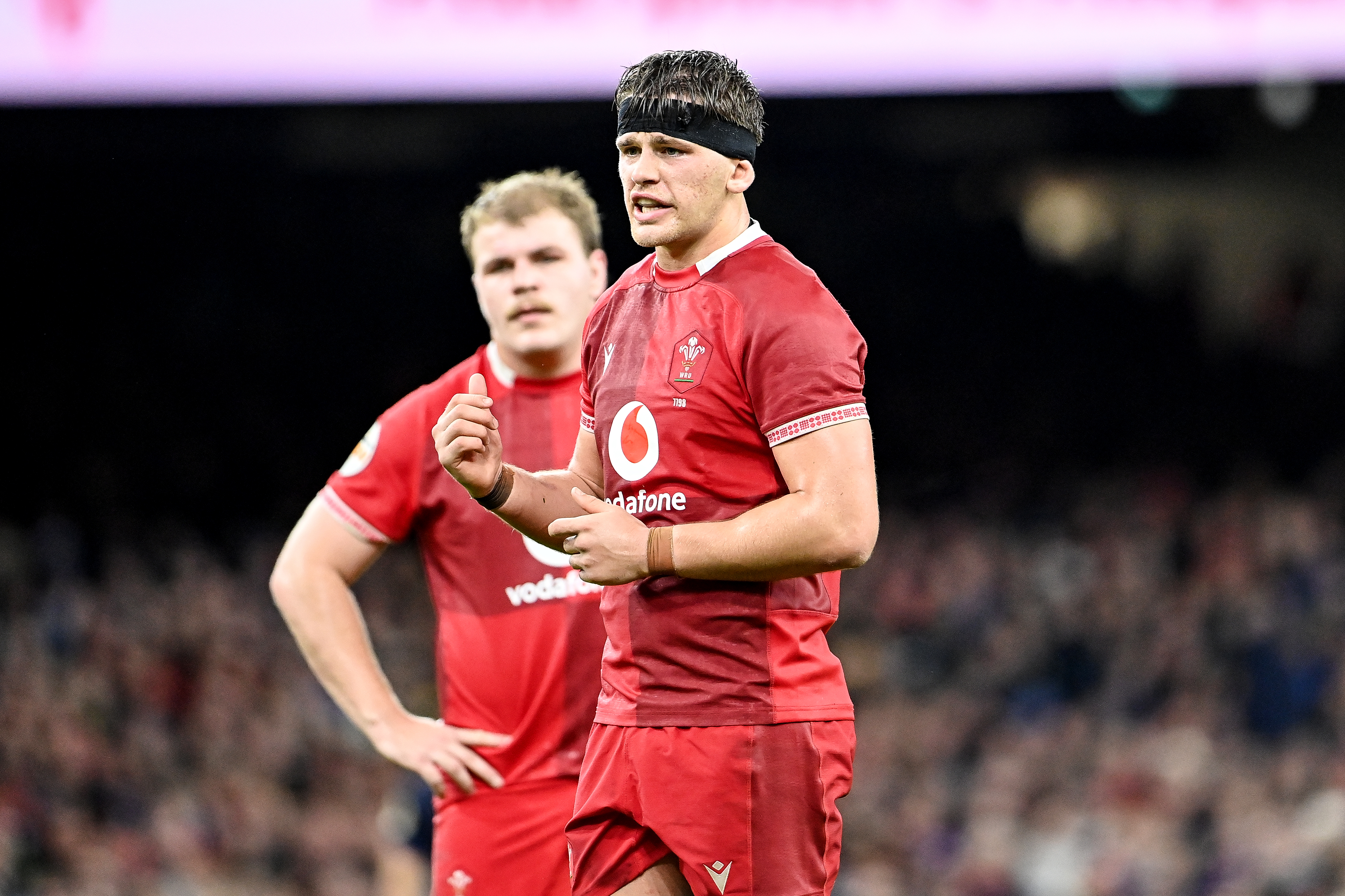 Wales' Alex Mann speaks to teammates during the 2026 Championship match against Scotland.
