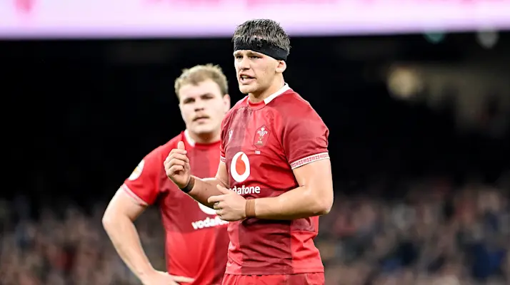 Wales' Alex Mann speaks to teammates during the 2026 Championship match against Scotland.