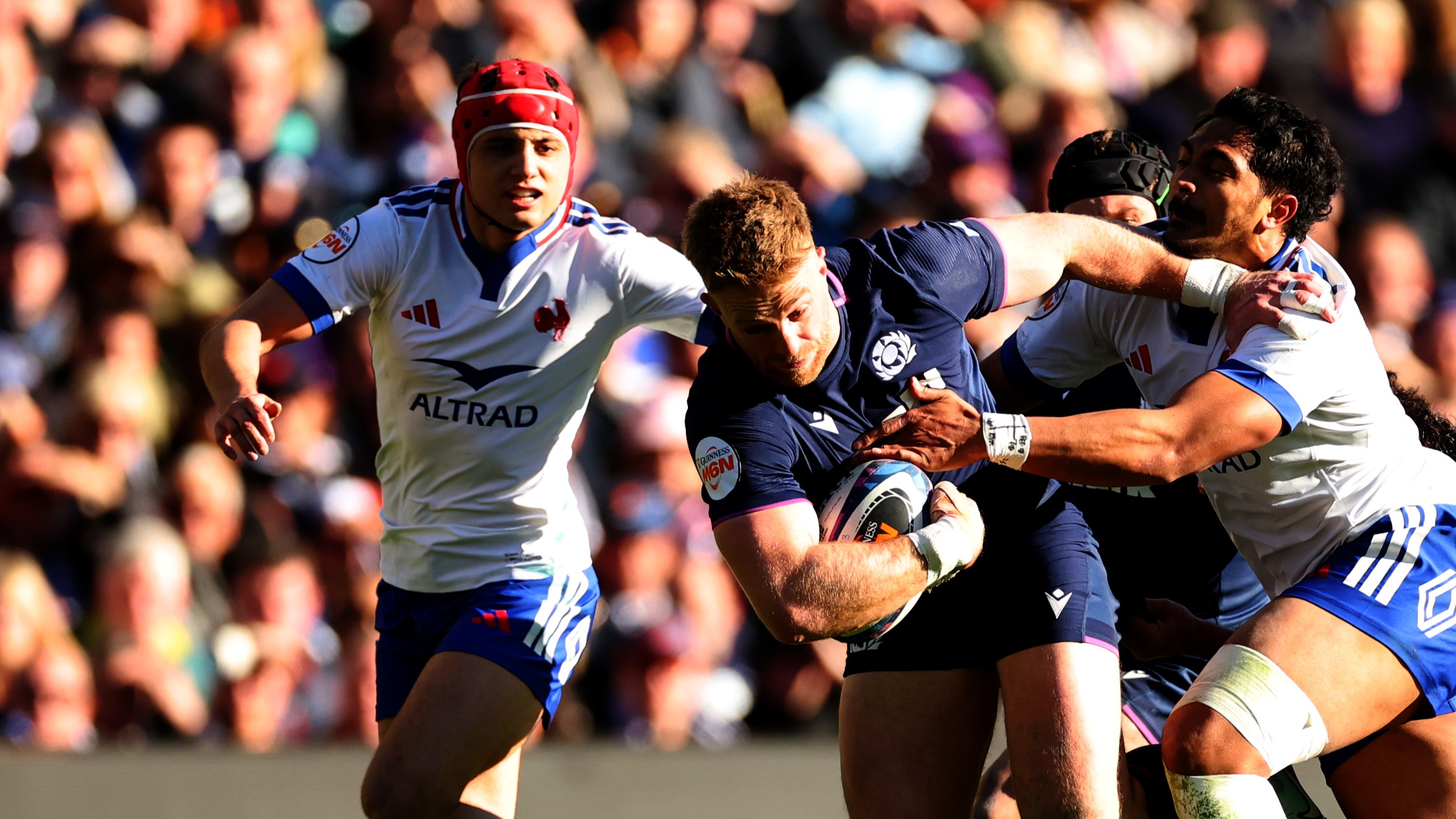 France's Louis Bielle-Biarrey and Yoram Moefana attempt to stop Scotland's Kyle Steyn during the 2026 Six Nations.
