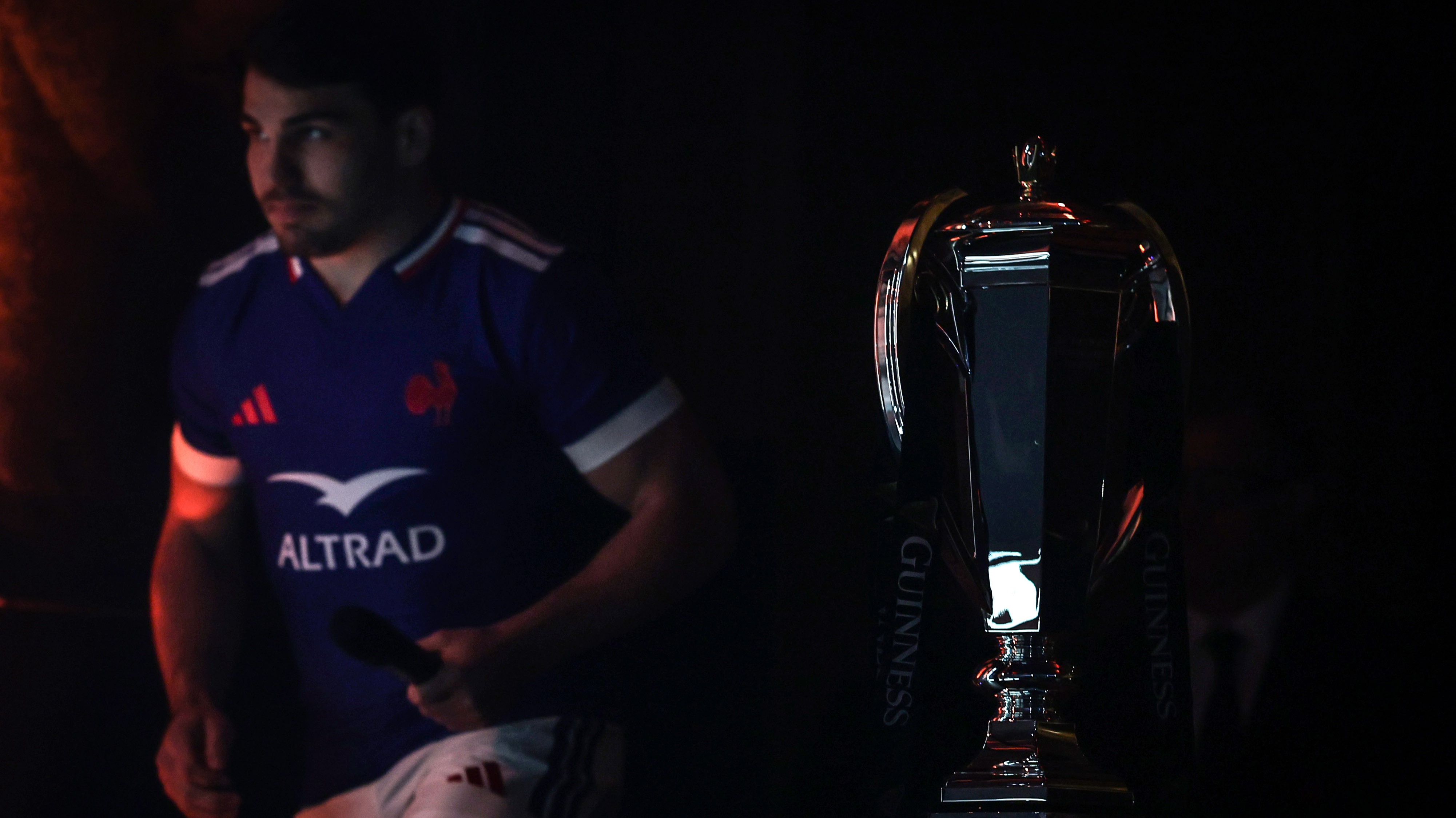 Antoine Dupont walks past the Championship trophy in the foreground at The Hub, Edinburgh.