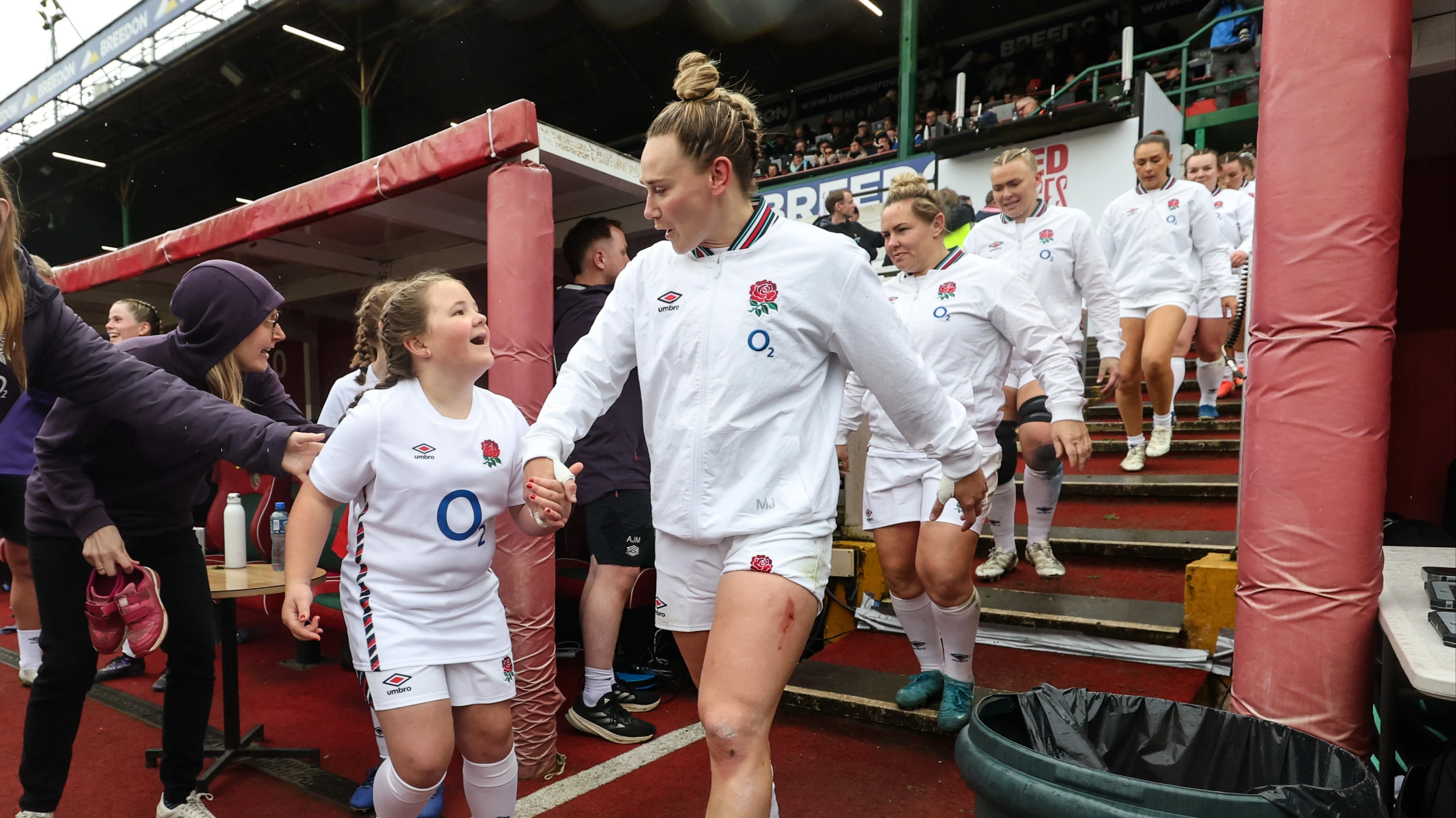 Meg Jones walks hand in hand with an England mascot ahead of the 2025 Guinness Women's Six Nations Round 4 game against Scotland in Mattioli Woods Welford Road Stadium, Leicester.
