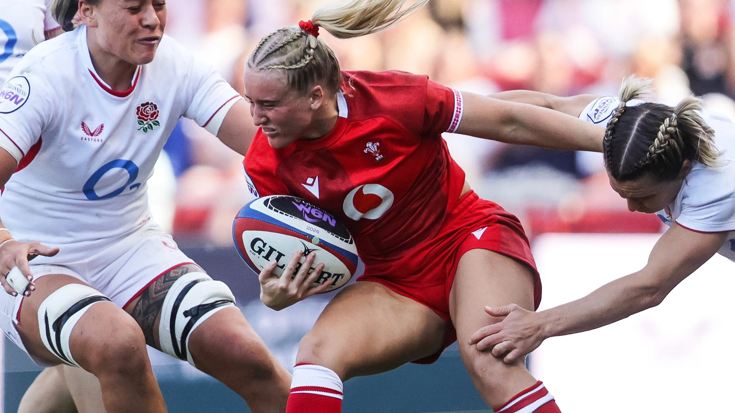 England's Maddie Feaunati and Claudia Moloney-MacDonald tackle Wales' Seren Singleton during the 2026 Guinness Women's Six Nations Championship Round 3 game between England and Wales in Ashton Gate Stadium, Bristol