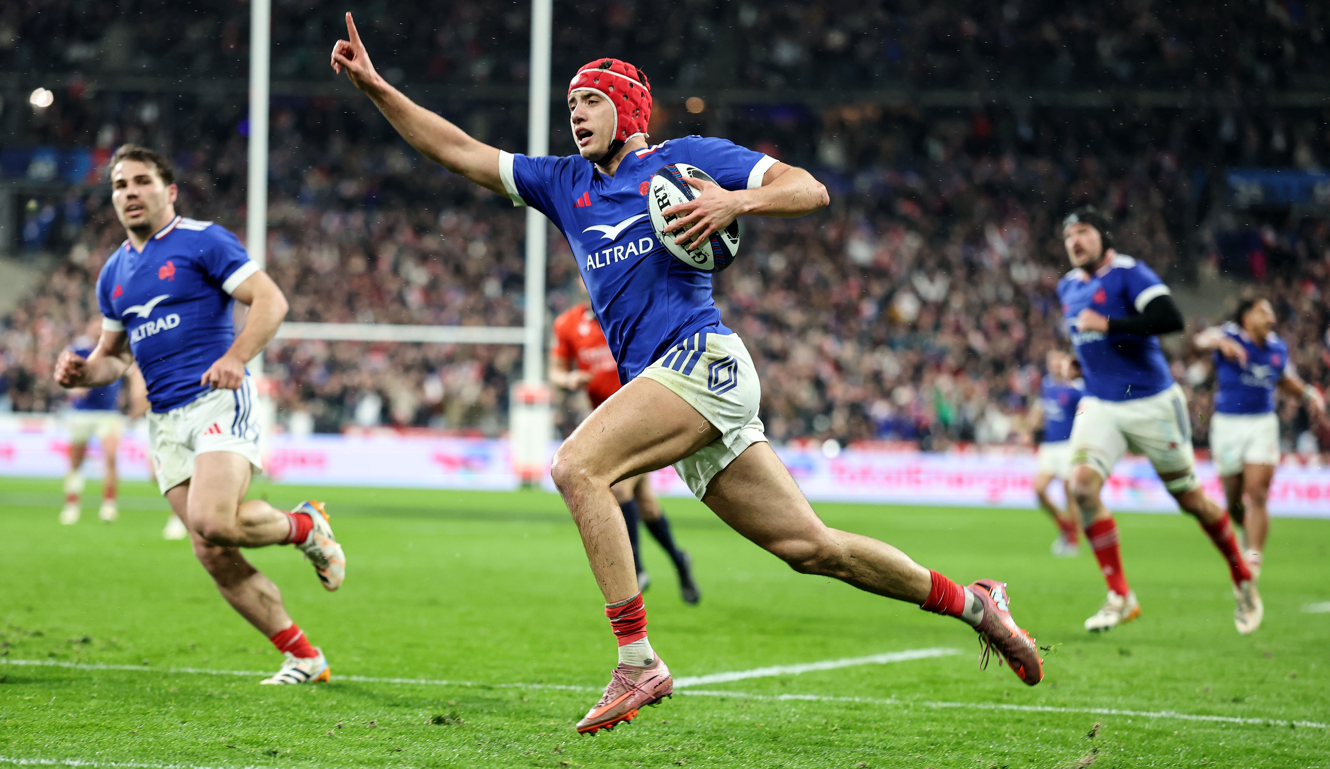 France's Louis Bielle-Biarrey raises an arm in celebration as he runs in a try against Ireland during the opening match of the 2026 Championship.