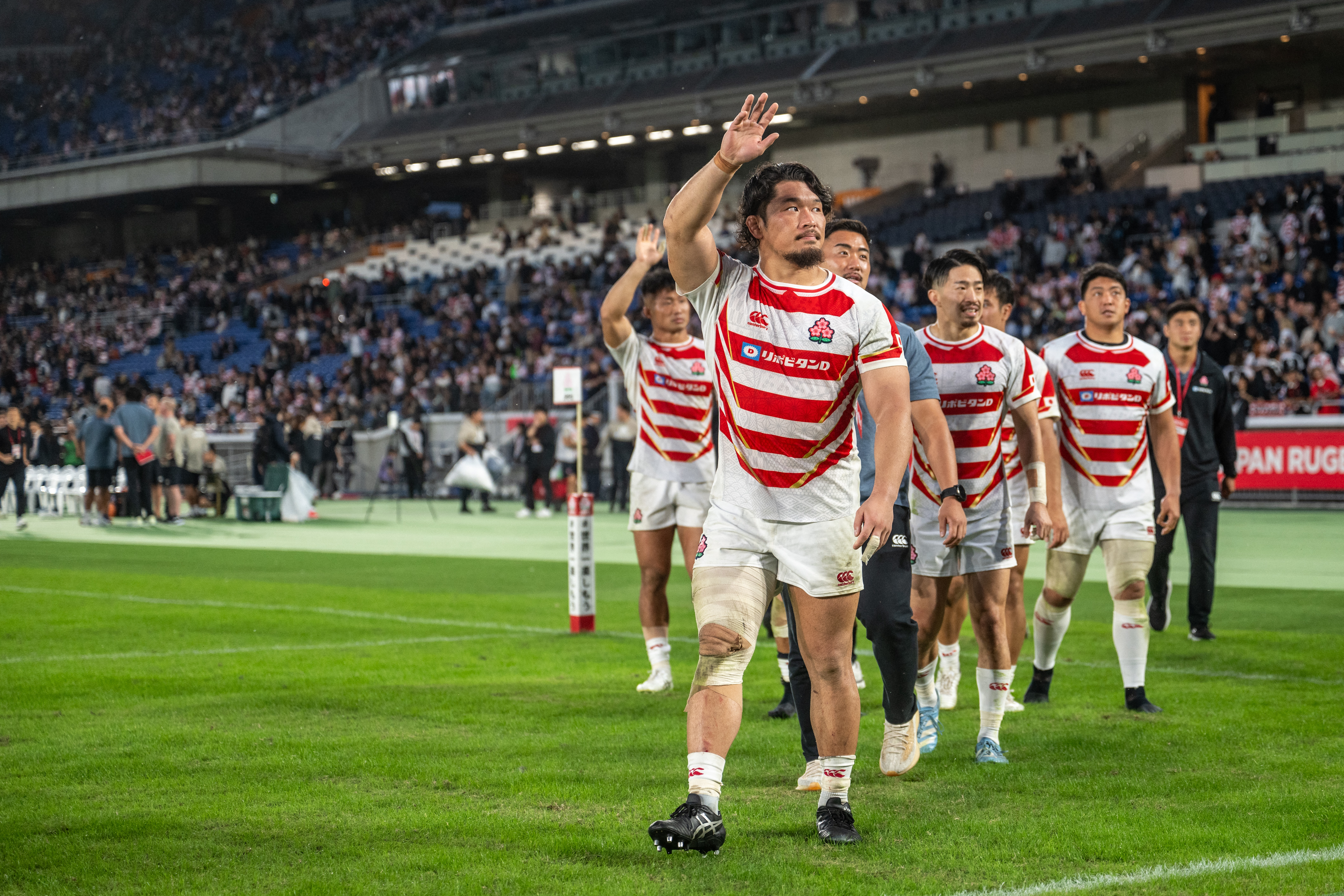 Japan's players wave to spectators after the rugby union test match between New Zealand and Japan at Nissan Stadium in Yokohama, Kanagawa prefecture, south of Tokyo, on October 26, 2024.