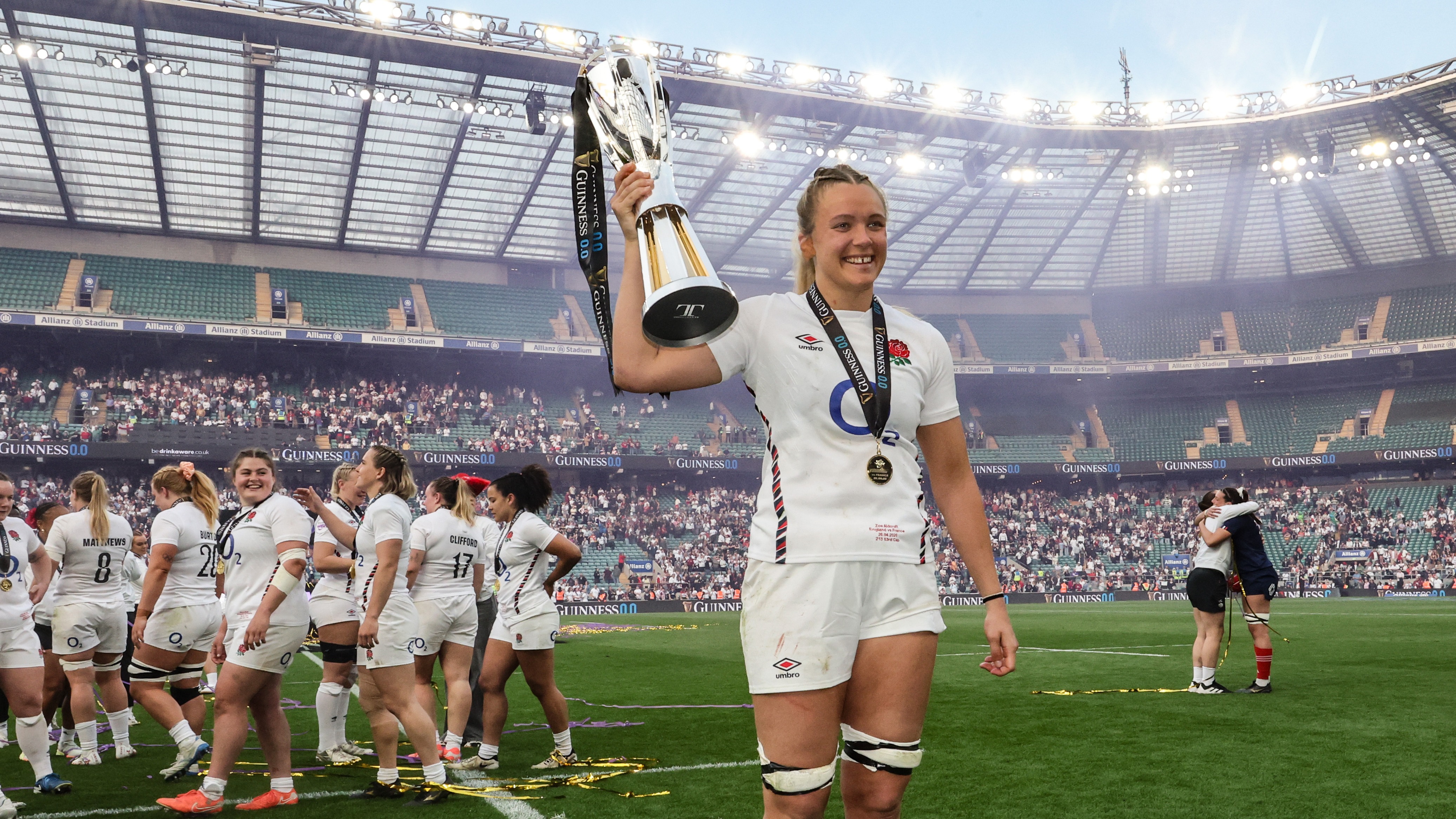 Zoe Aldcroft holds the 2026 Championship trophy as her teammates do a lap of honour at Allianz Stadium.