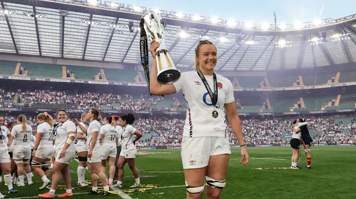 Zoe Aldcroft holds the 2026 Championship trophy as her teammates do a lap of honour at Allianz Stadium.
