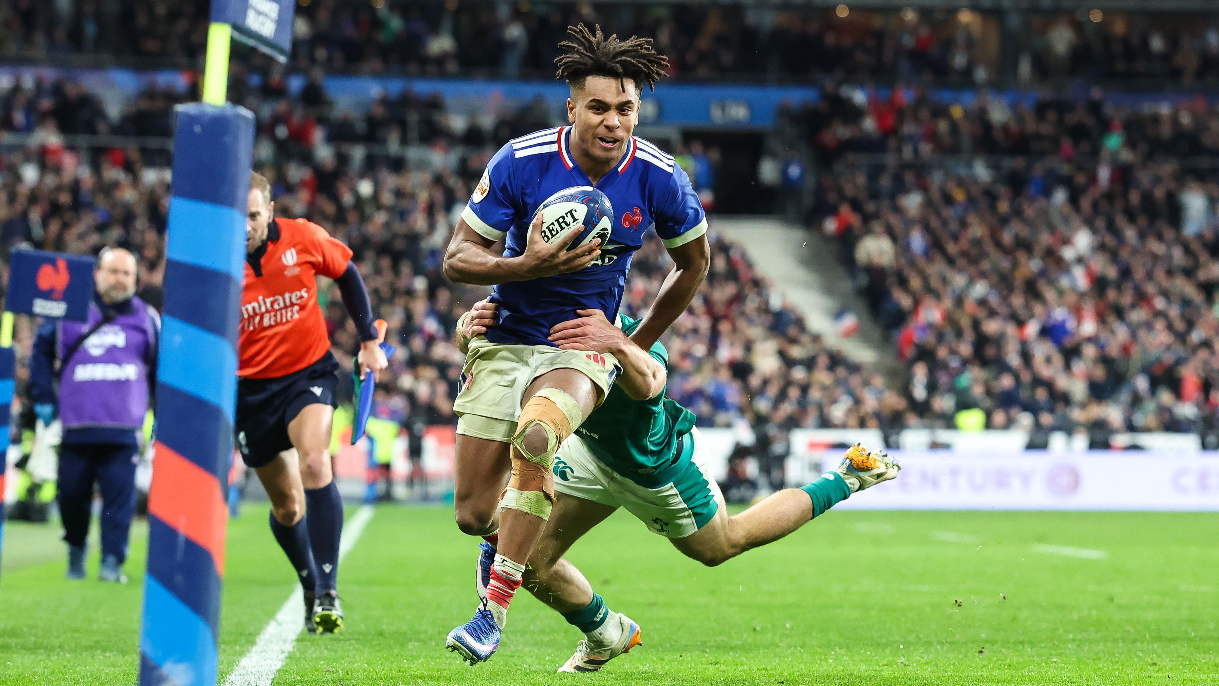 France's Theo Attissogbe runs in to score against Ireland despite the attentions of a diving Jack Crowley during the 2026 Championship.