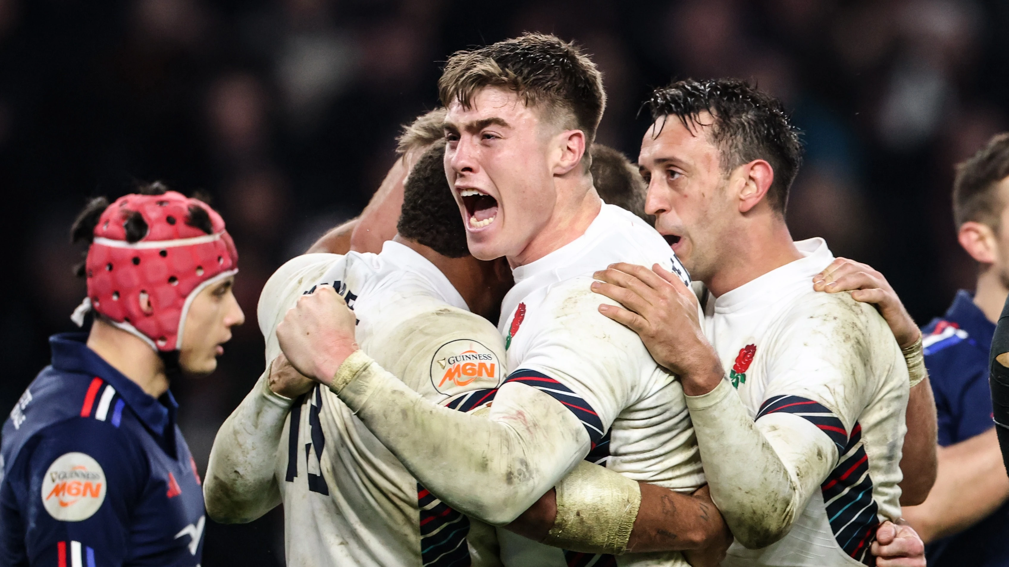 England's Tommy Freeman, Elliot Daly and Ollie Lawrence swarm Elliot Daly after he scores the winning try against France in the 2025 Championship.