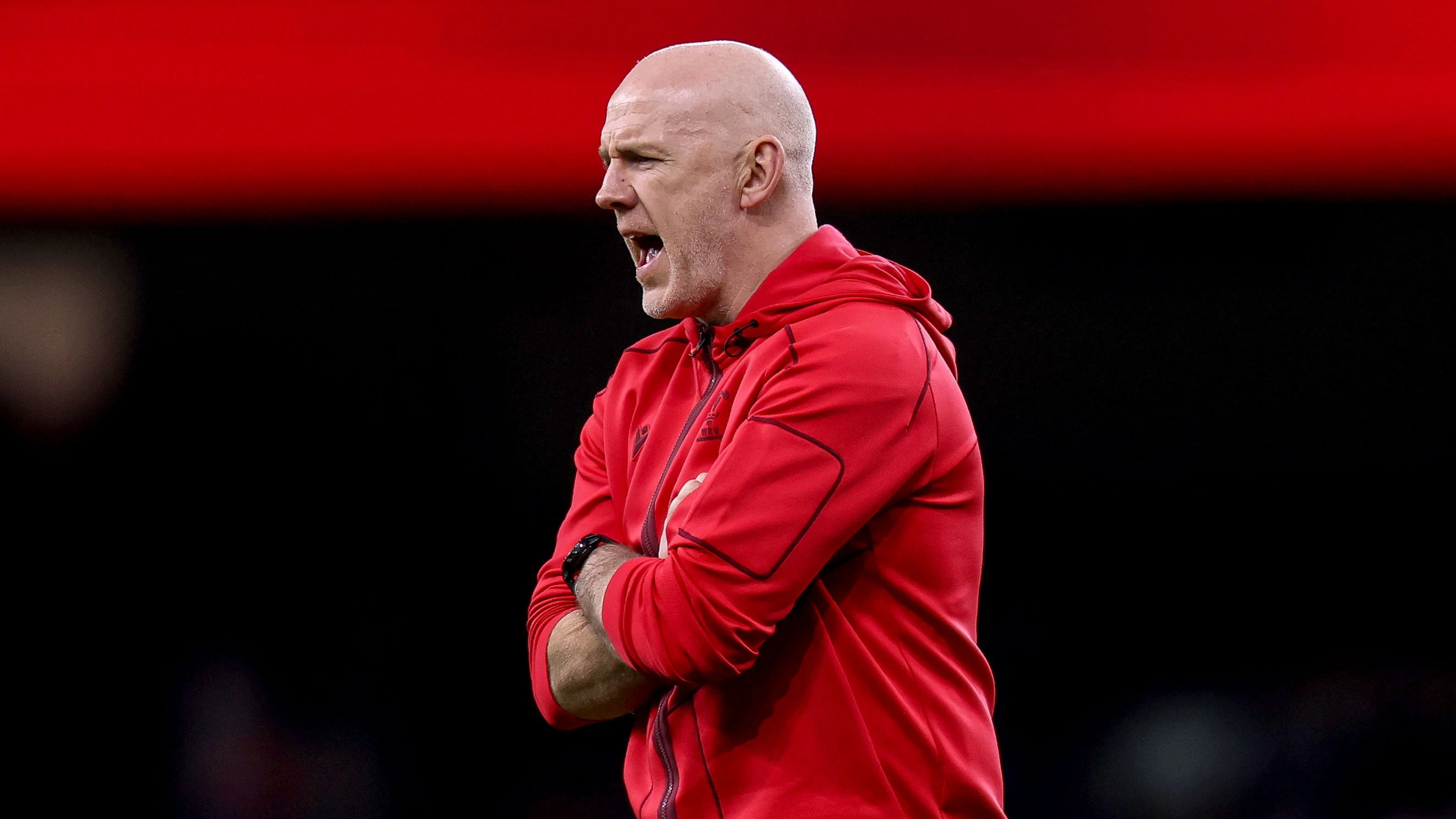 Wales head coach Steve Tandy shouts orders at his team during a warm-up at the Principality Stadium in the 2026 Championship.