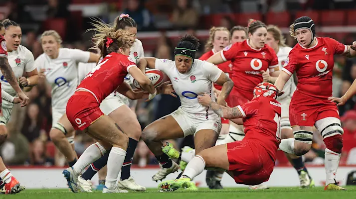 England's Sadia Kabeya is tackled by Wales' Lisa Neumann and Donna Rose during the 2025 Guinness Women's Six Nations Championship Round 2 game between Wales and England in the Principality Stadium, Cardiff