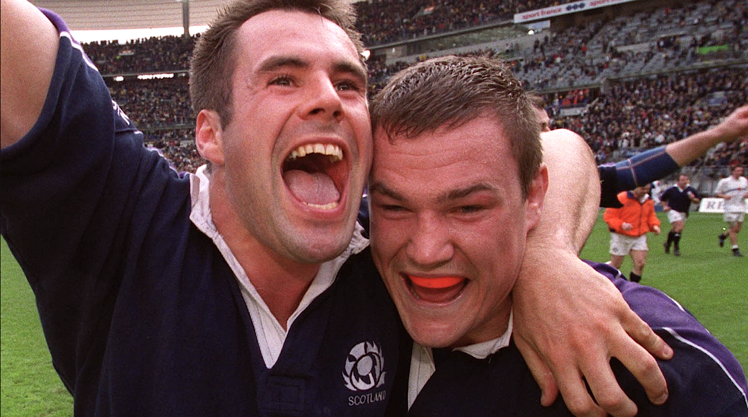 Kenny Logan and Gordon Bulloch celebrate beating France during the 1999 Five Nations.