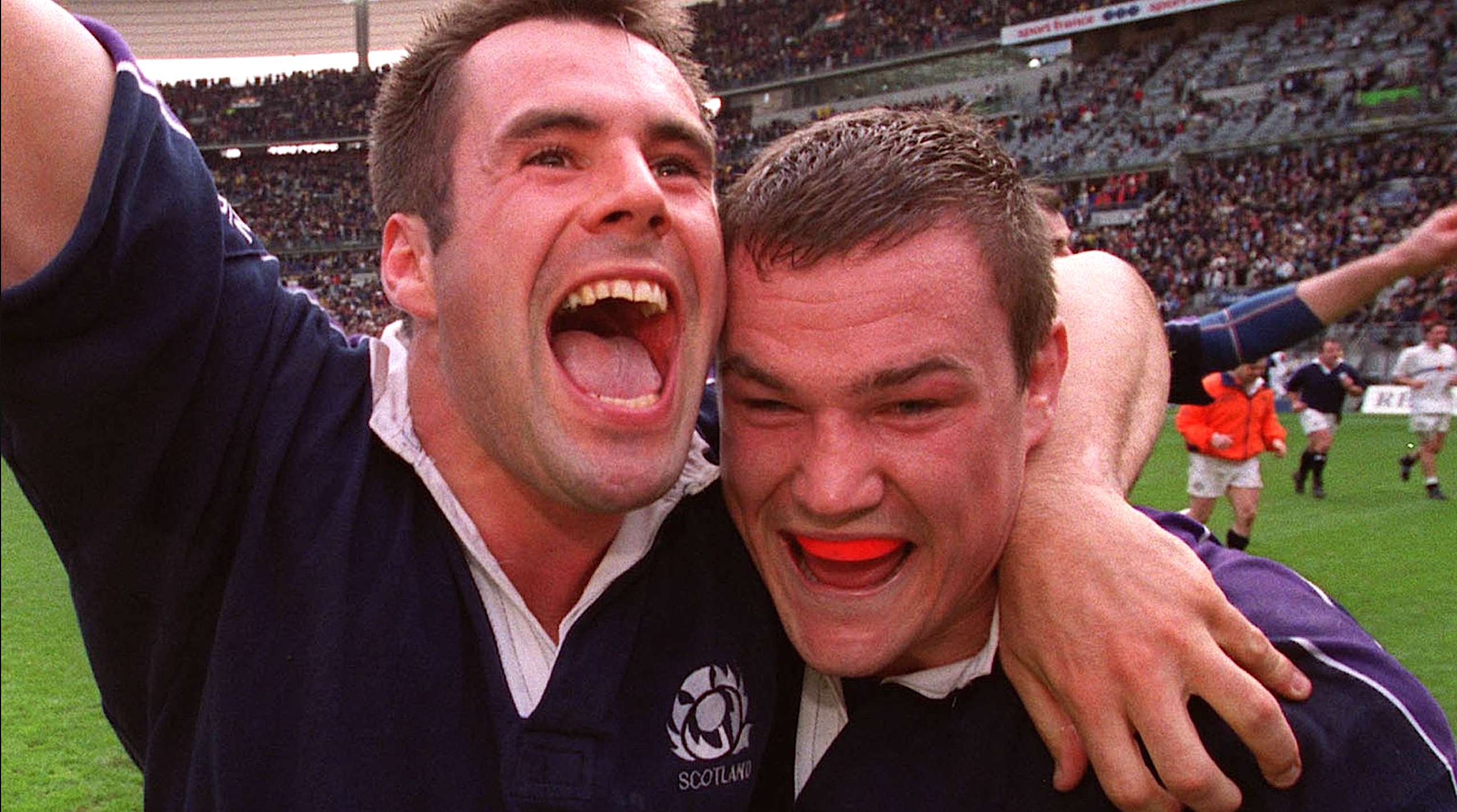 Kenny Logan and Gordon Bulloch celebrate beating France during the 1999 Five Nations.