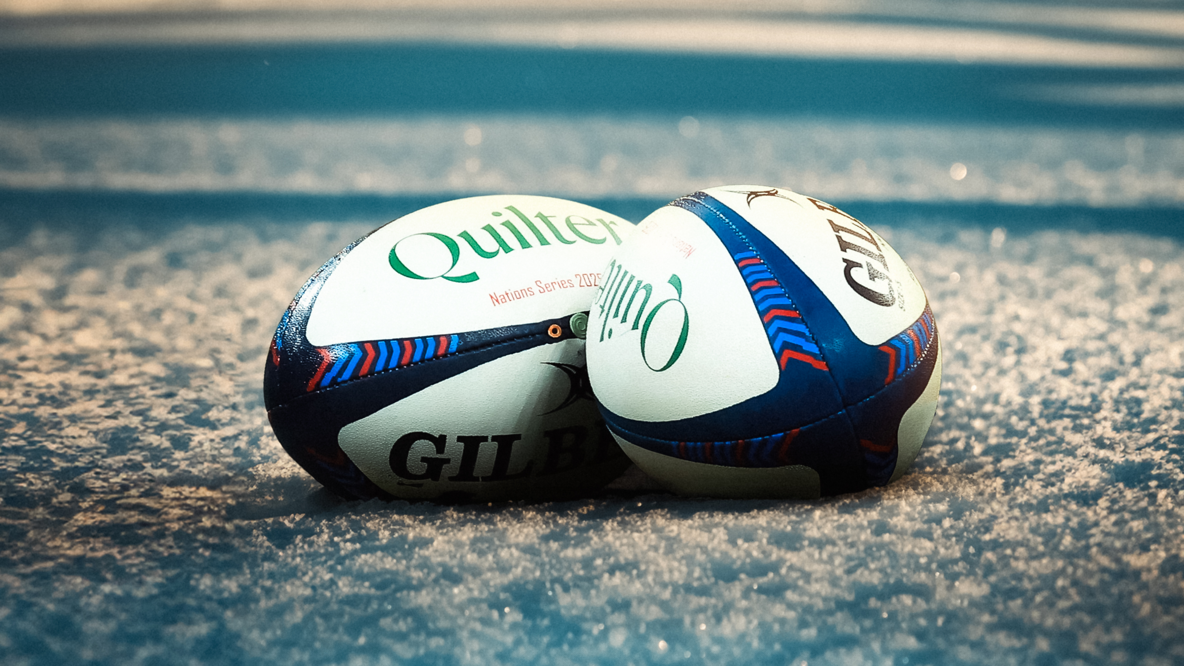 A view of two Quilter Nations Series rugby balls.
