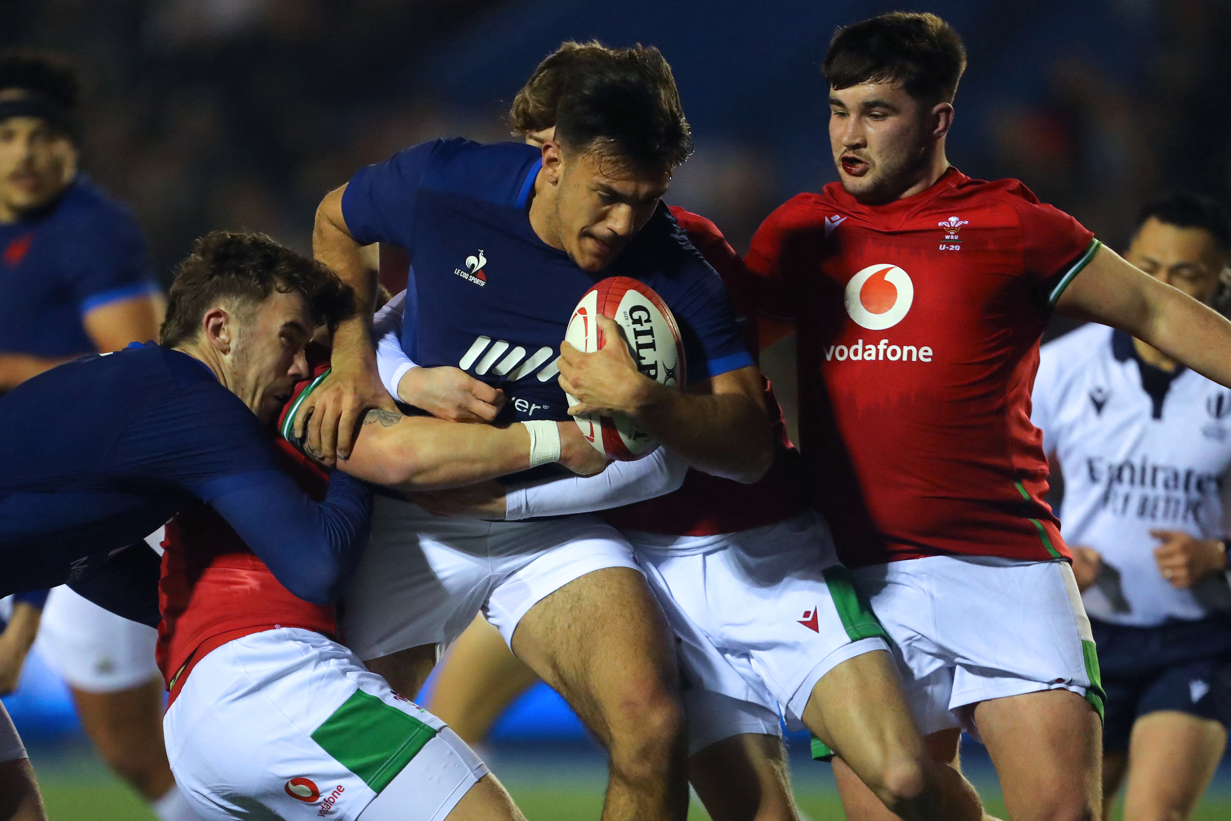 France U20's centre Mathys Belaubre (C) is tackled during the U20 Six Nations international rugby union match between Wales and France at Cardiff Arms Park in south Wales on March 7, 2024. (Photo by Geoff Caddick / AFP)